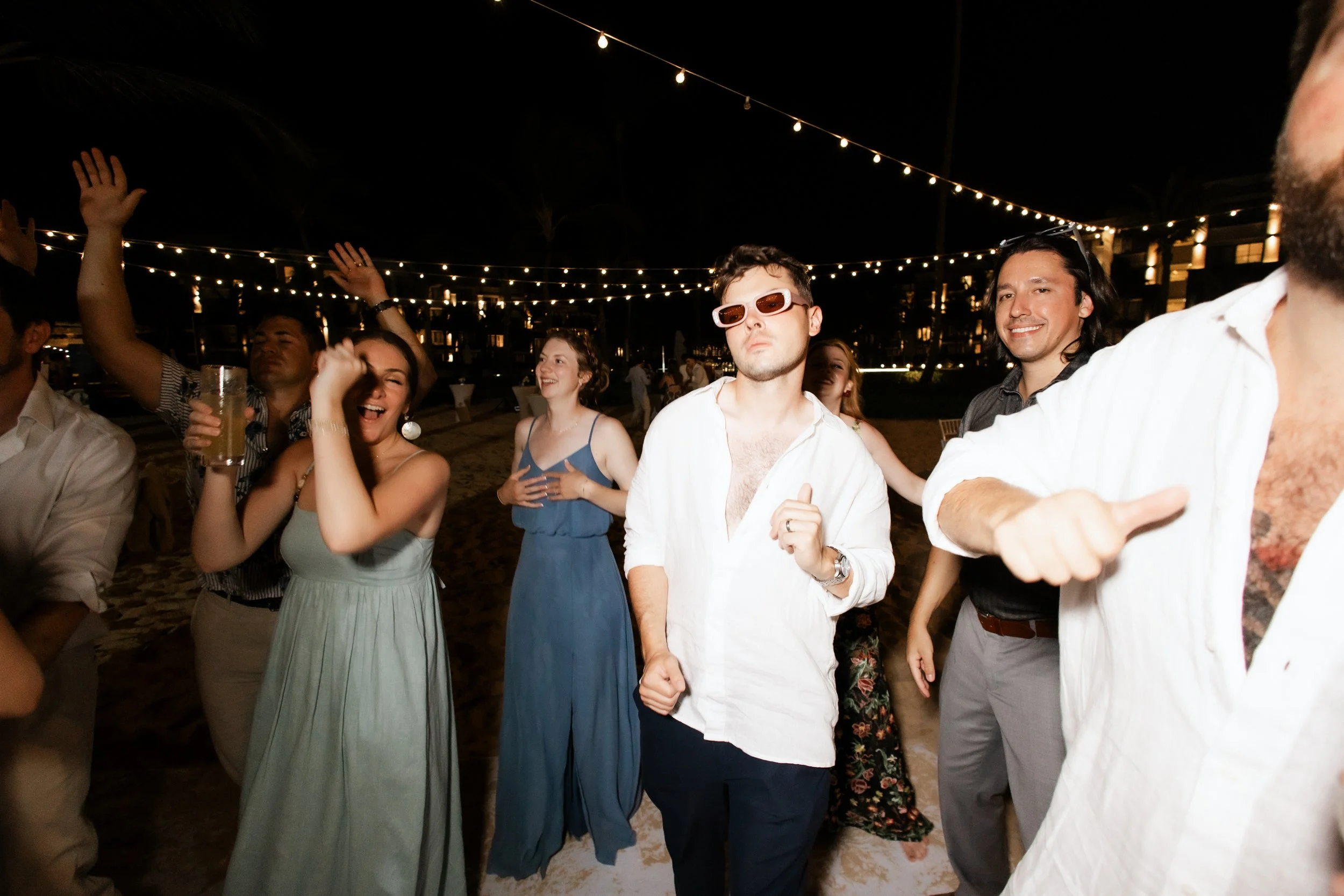 secrets-tides-wedding-reception-guests-dancing-string-lights.jpg