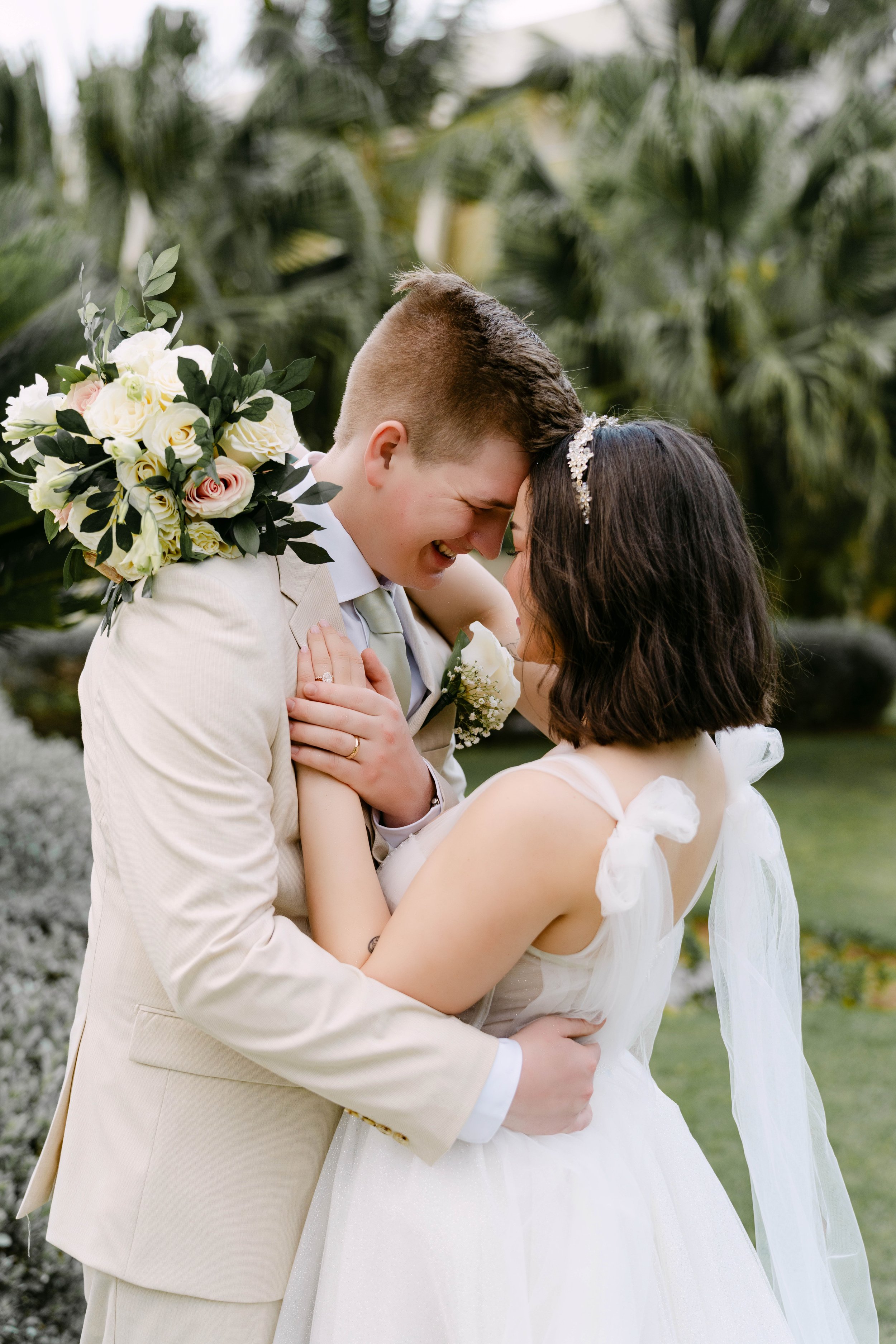 Bride and groom embracing in the gardens at Dreams Onyx Punta Cana