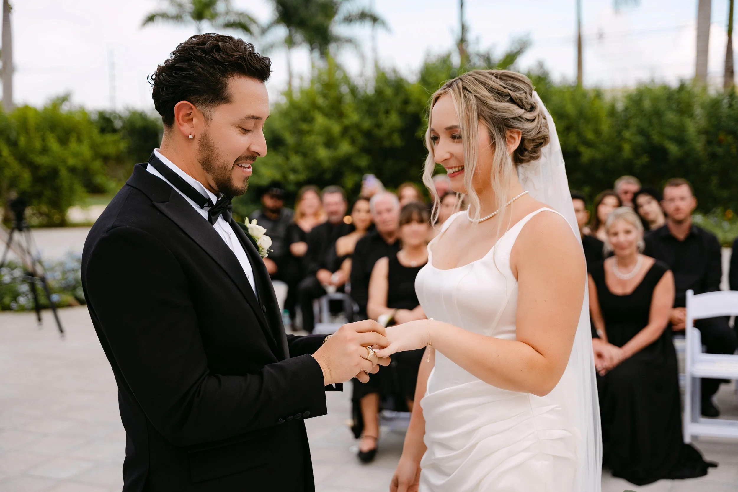 Black-tie wedding ceremony with guests in all black at Secrets Tides Punta Cana