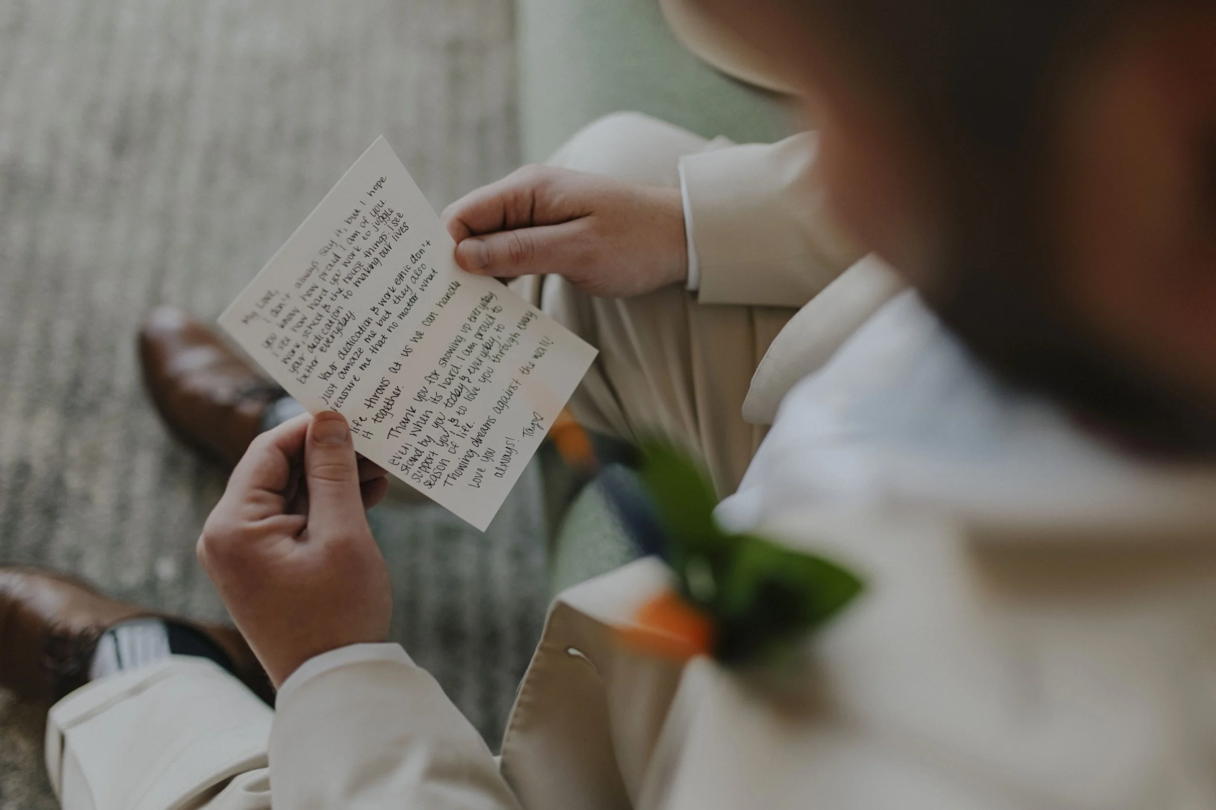 Groom reading a handwritten letter from his bride while getting ready at a Secrets Tides wedding