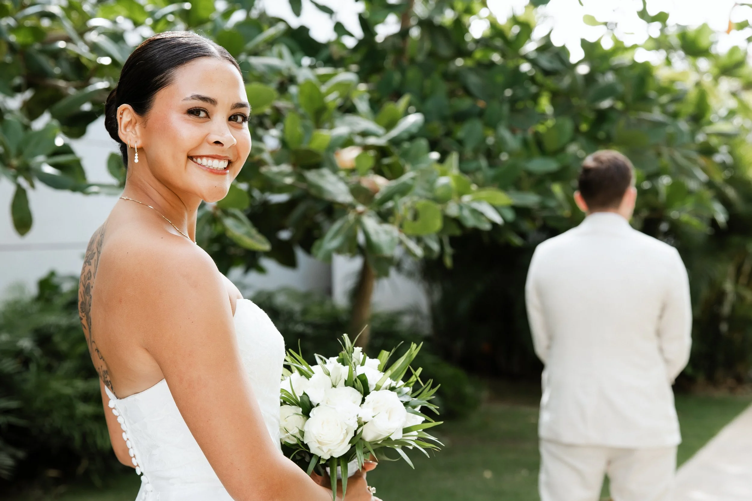 secrets-tides-first-look-bride-smiling-over-shoulder.jpg