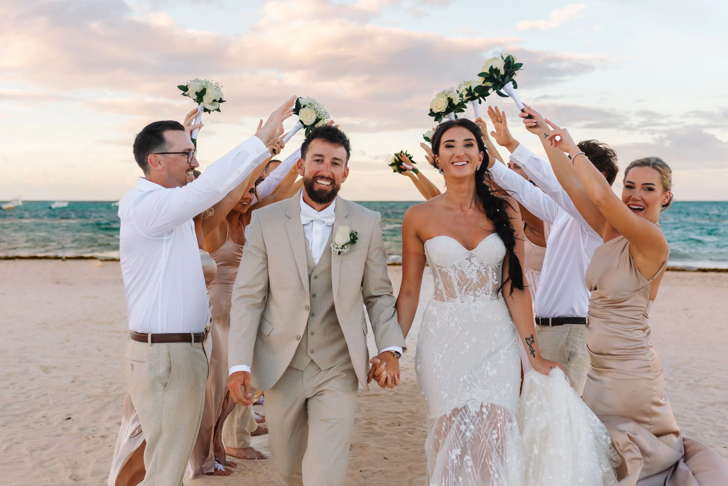 Brianna and Joshua celebrating after their beachfront wedding ceremony at Secrets Royal Beach