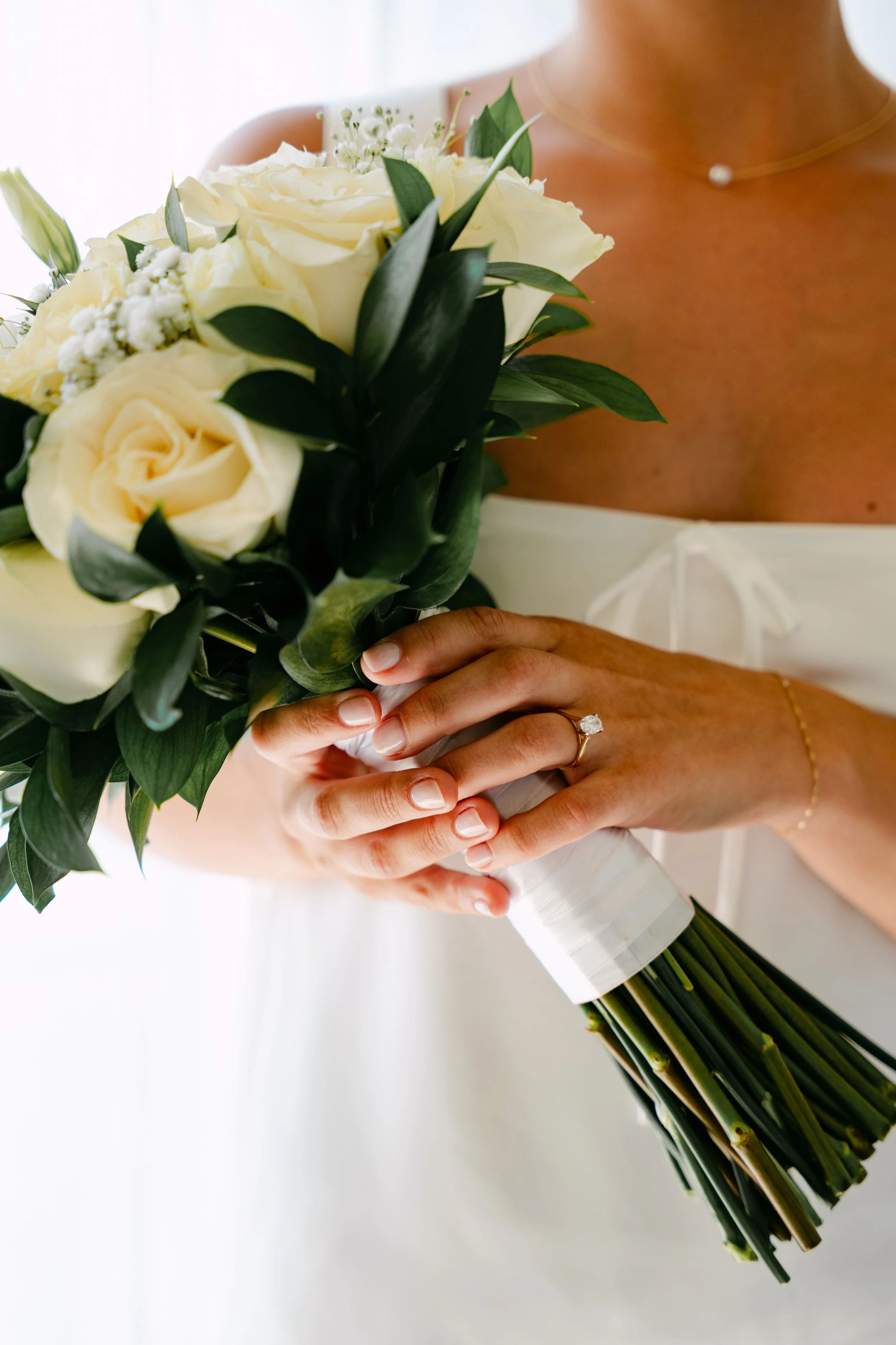 Bride holding white rose bouquet with wedding ring detail, Dreams Royal Beach Punta Cana wedding by WBA Studio.