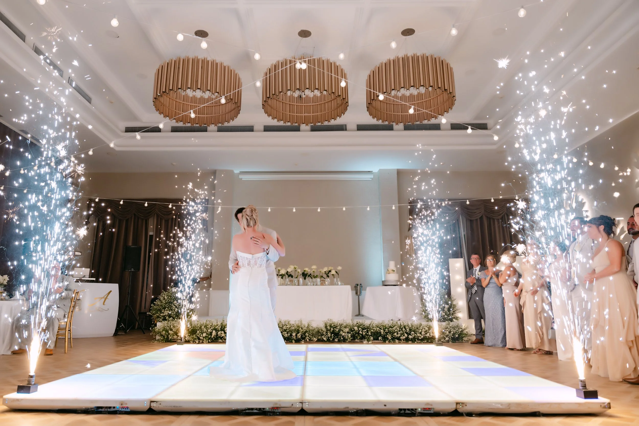 Bride and groom's first dance surrounded by sparklers at their Majestic Punta Cana reception