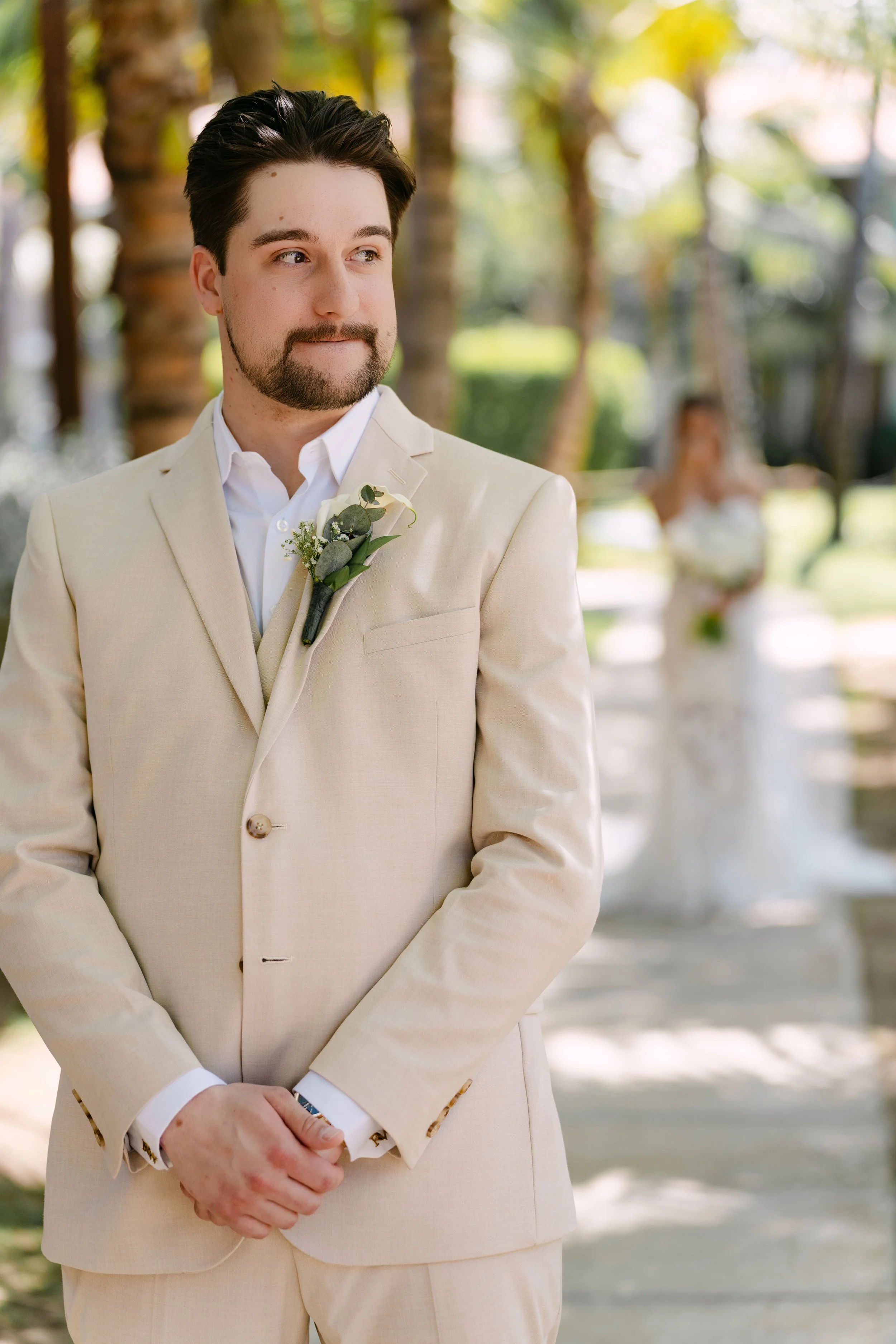 Groom waiting anxiously as his bride approaches for their Punta Cana first look