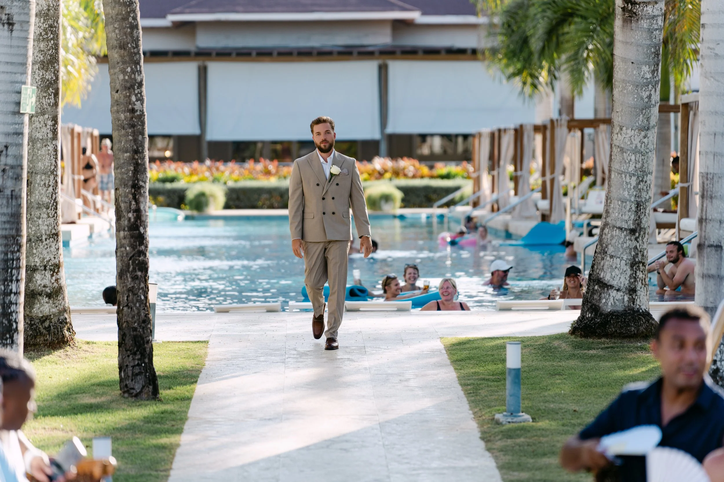 secrets-royal-beach-groom-tan-suit-garden-path.jpg