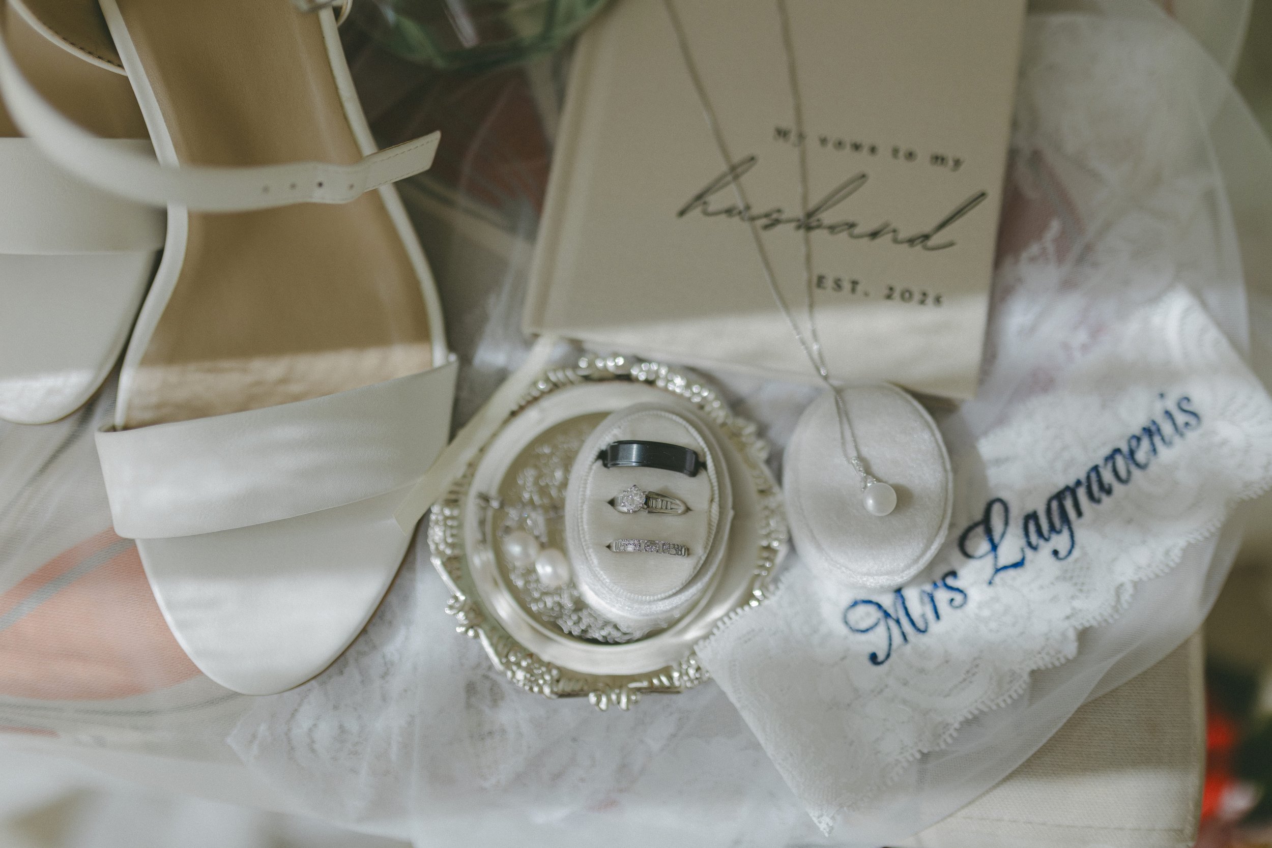 Bride's wedding shoes, rings, and personalized robe detail at Dreams Royal Beach