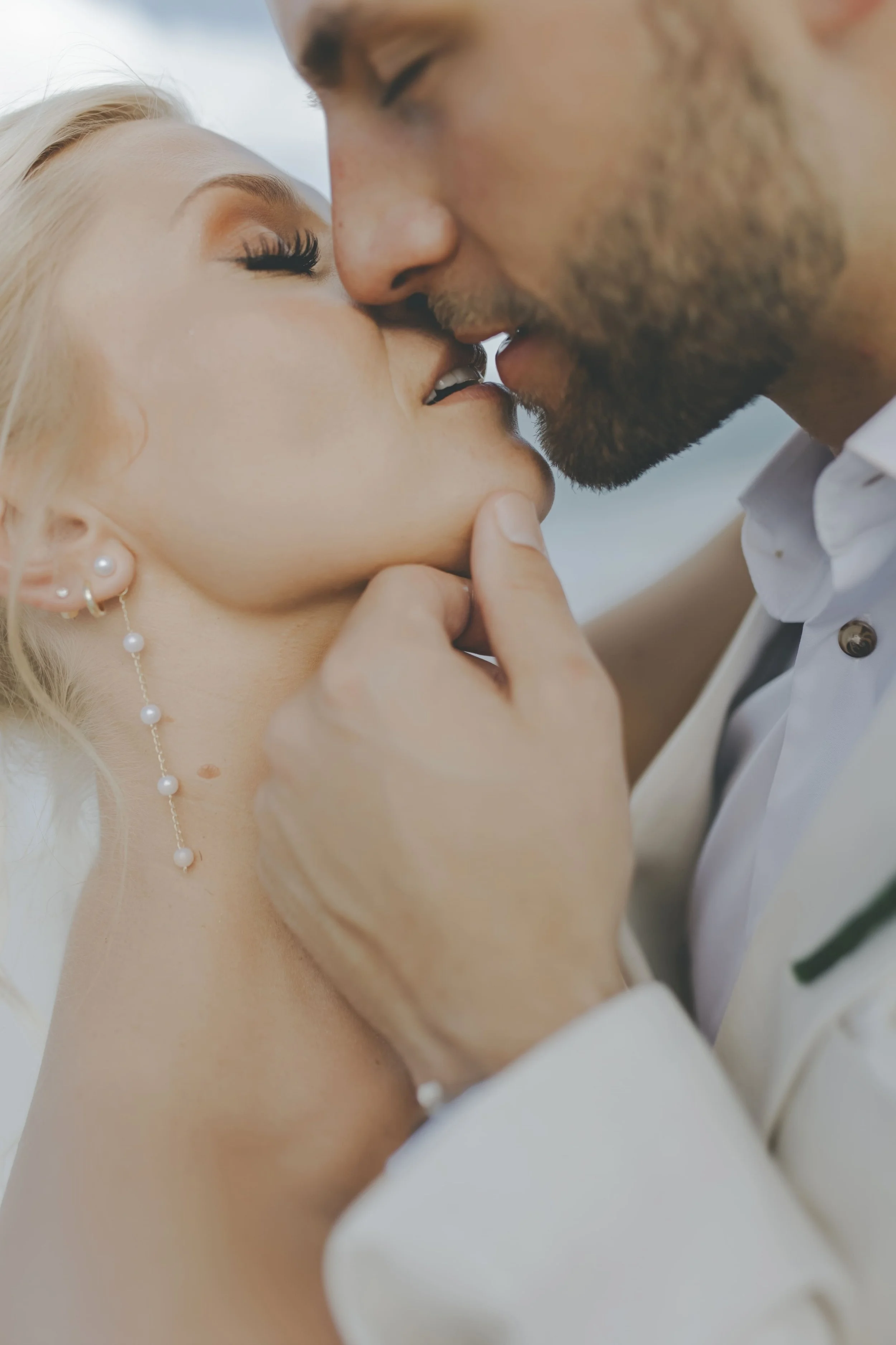 Groom holding his bride's face during an intimate wedding portrait in Punta Cana
