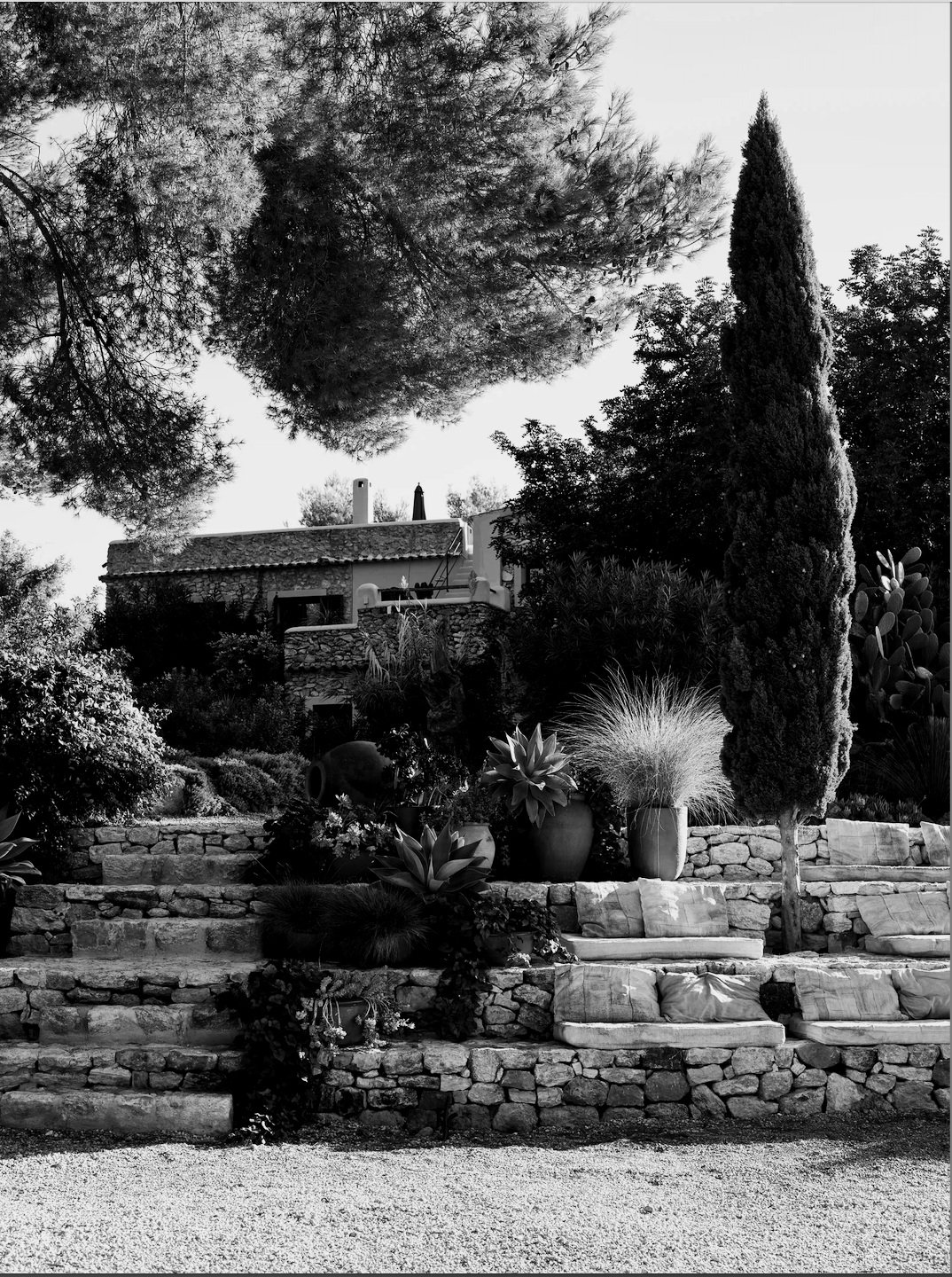 Exterior view of La Granja in Ibiza, surrounded by lush gardens and traditional Mediterranean architecture
