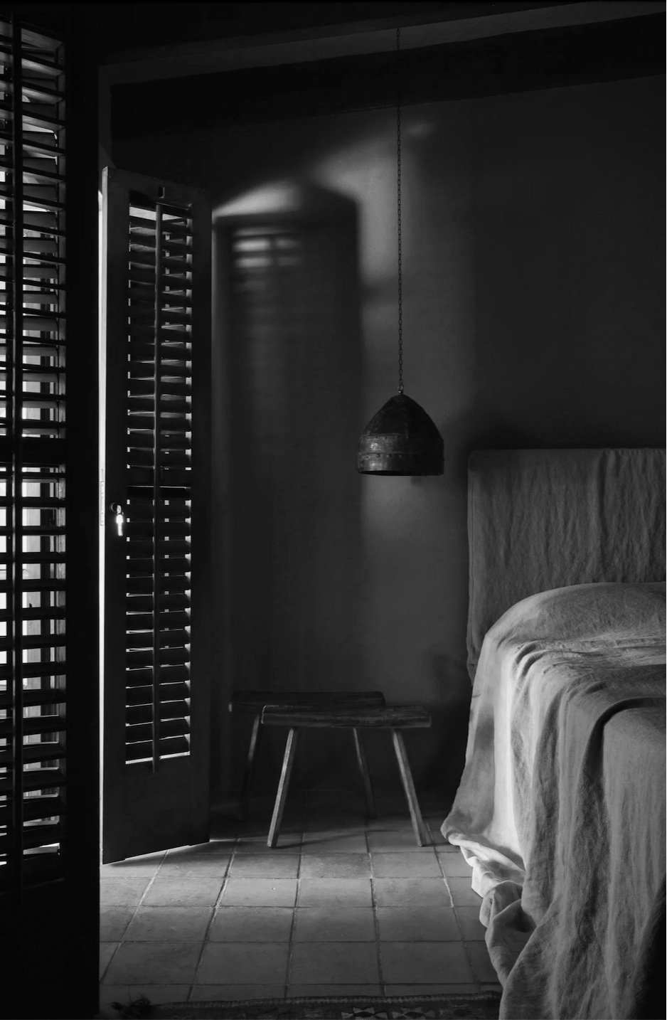 Guest room at La Granja in Ibiza, with minimalist design and natural light, offering a tranquil retreat.