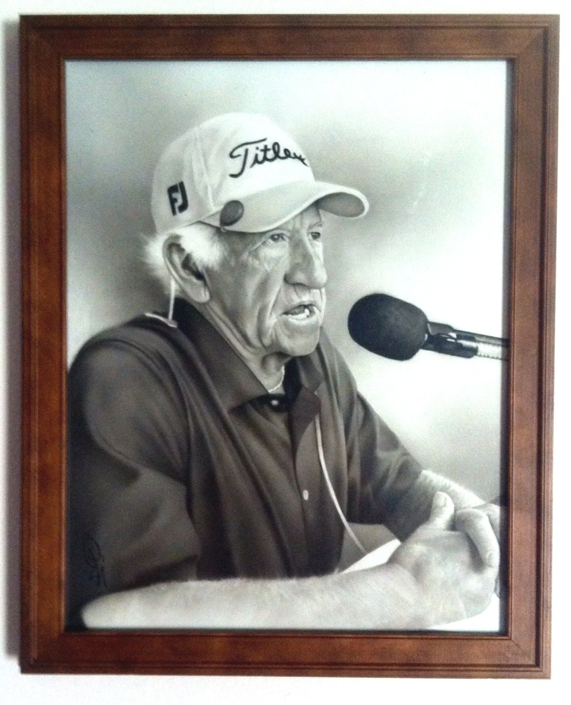 Hand-painted portrait of Bob Uecker announcing into a microphone, created by Eli Vallejo.