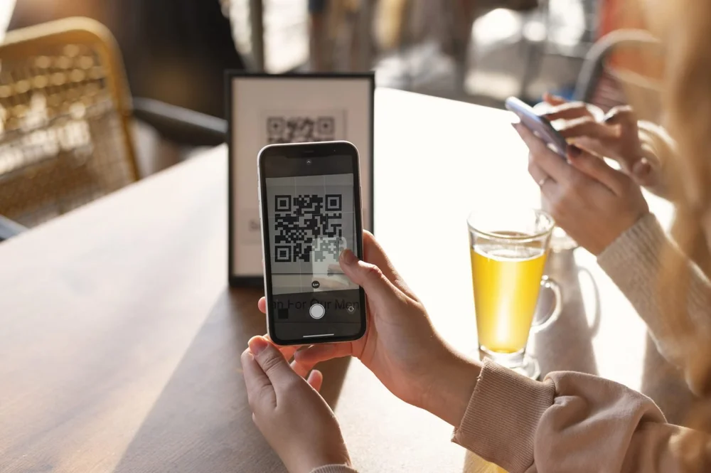 A guest scanning a table QR code with their phone