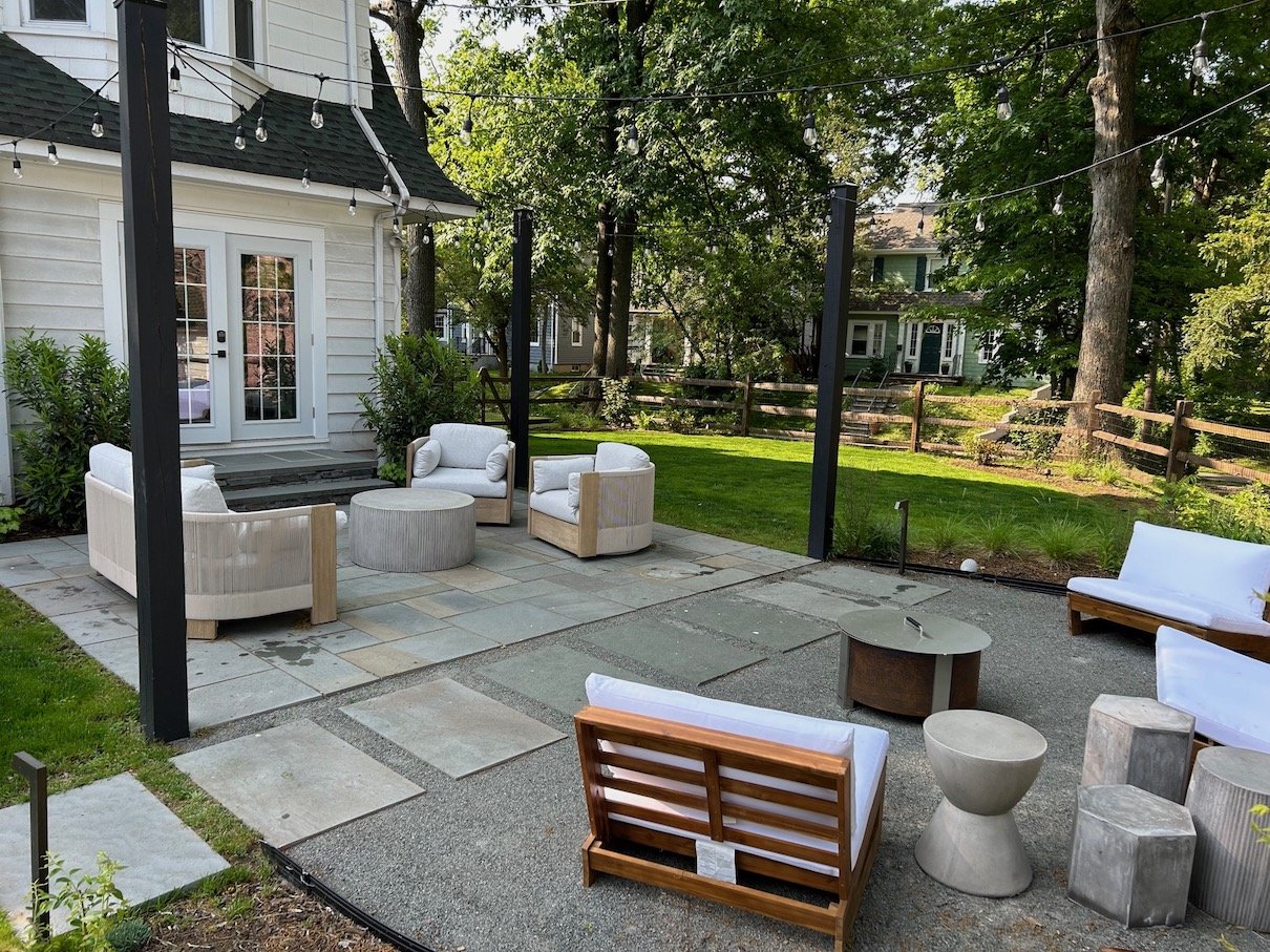 Natural stone patio with perimeter native plantings and a shade sail canopy for reprieve from the hot afternoon sun in Northern NJ backyard.jpg