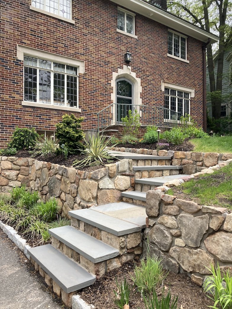 Stone step entrance walkway with tiered landscaping in Northern NJ home front yard.jpg