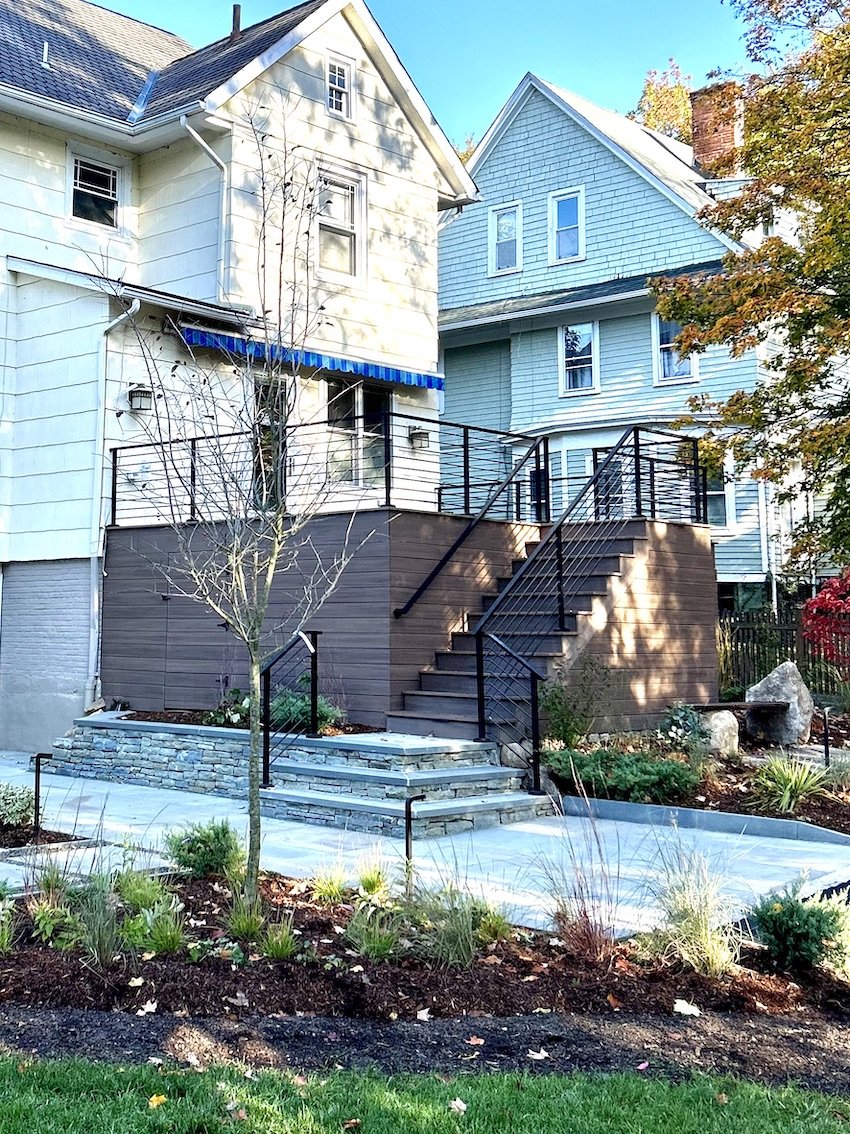 Outdoor deck with wood steps, black metal detailling and stonework for 2 floor home in maplewood nj.jpg