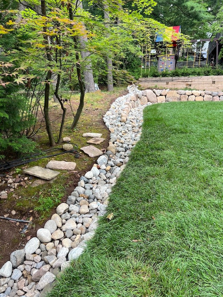 River stone swale for yard drainage.jpg