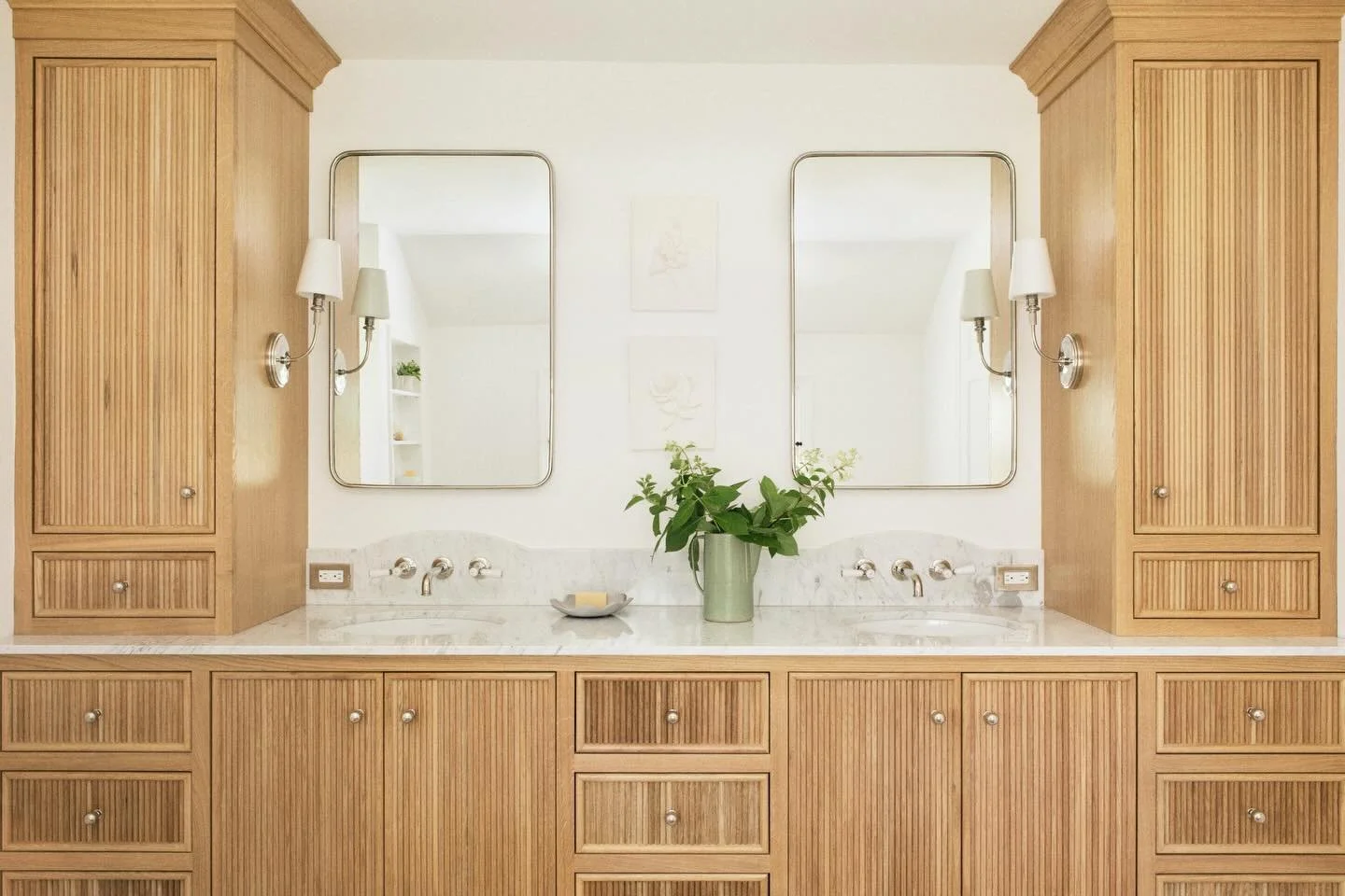 Natural wood, soft marble, and symmetry. 

A little serenity never looked so good. 🤍

We loved designing this primary bedroom for our clients. We wanted to inject a calm and elevated feel into this space through the elements used - marble, warm wood