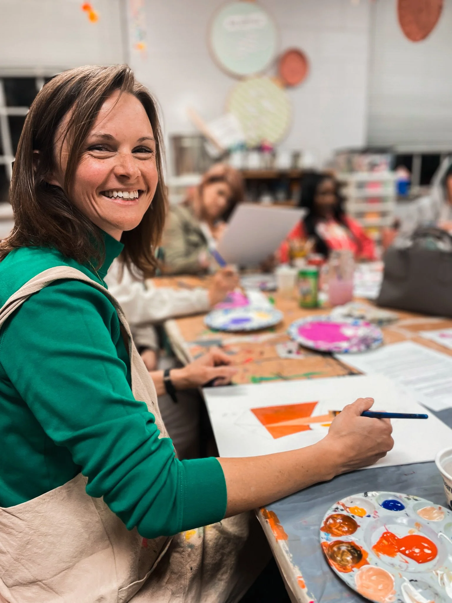 Art teacher volunteer painting with acrylic paint at Creative studio in Richmond VA