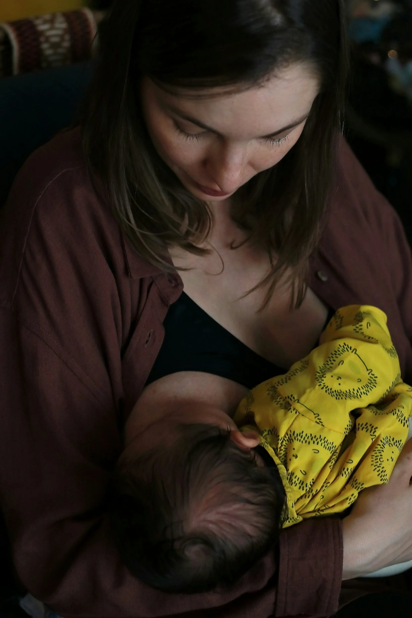 Mother breastfeeding an infant, supporting feeding coordination and oral motor development.