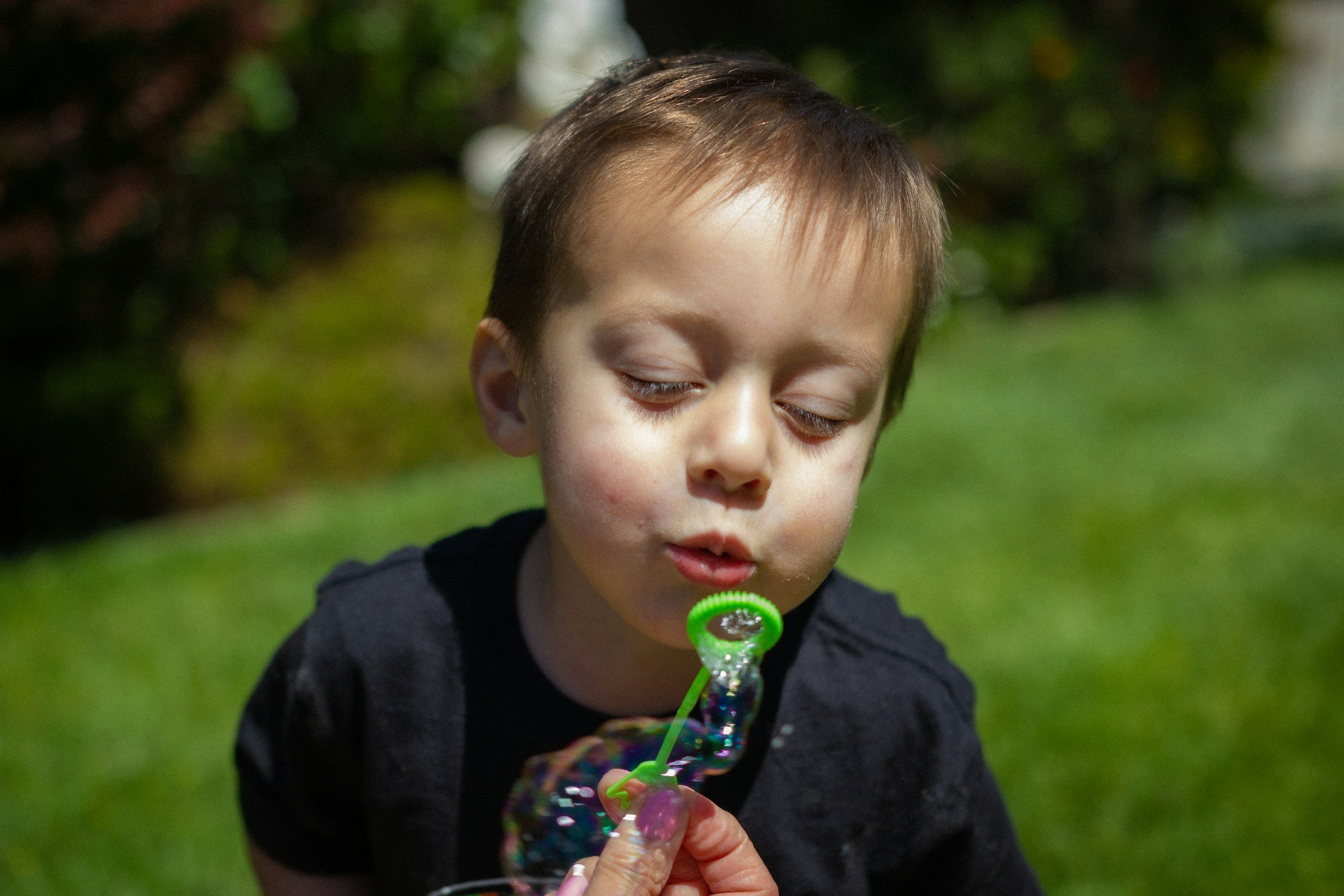 Child using controlled breathing and play to support calming and self-regulation.