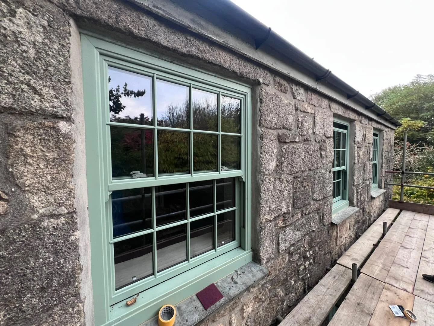 ✨ Window transformation! ✨
We resprayed these uPVC sash windows from a dated green to the elegant Portland Stone Dark by Little Greene Paint Company.

The lighter tone completely lifts the look of this granite cottage, giving it a timeless, clean fin