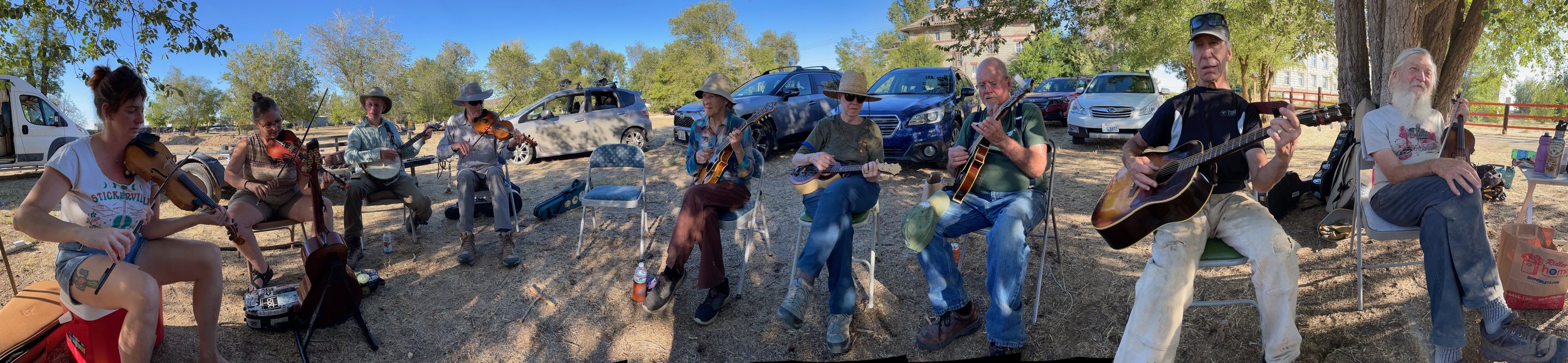 Volunteers jamming in the shade after working hard: Kate Little (Treasurer), Zondra Skertich (Vice President), Keith Walklet (Project Photographer), Dave Daley (Manual Laborer & Cook), Becky Smith (President), Kay Hummel (Manual Laborer & Cook), Bill