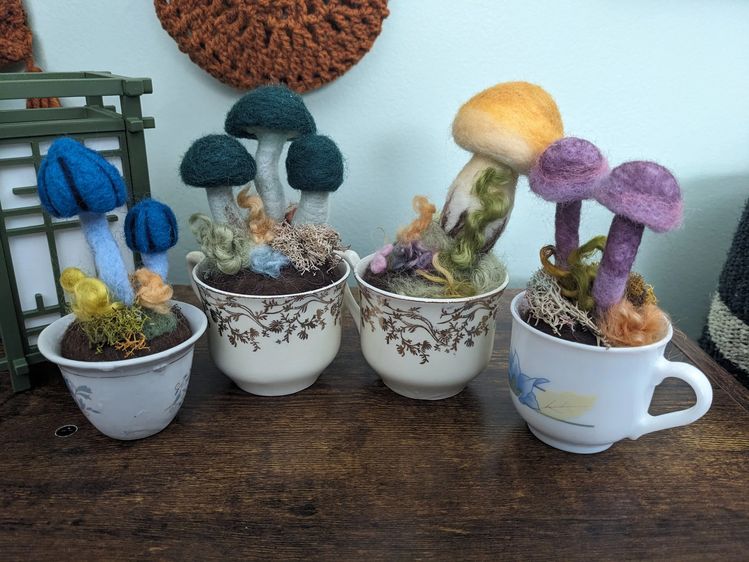 Four needle felted mushrooms in tea cups