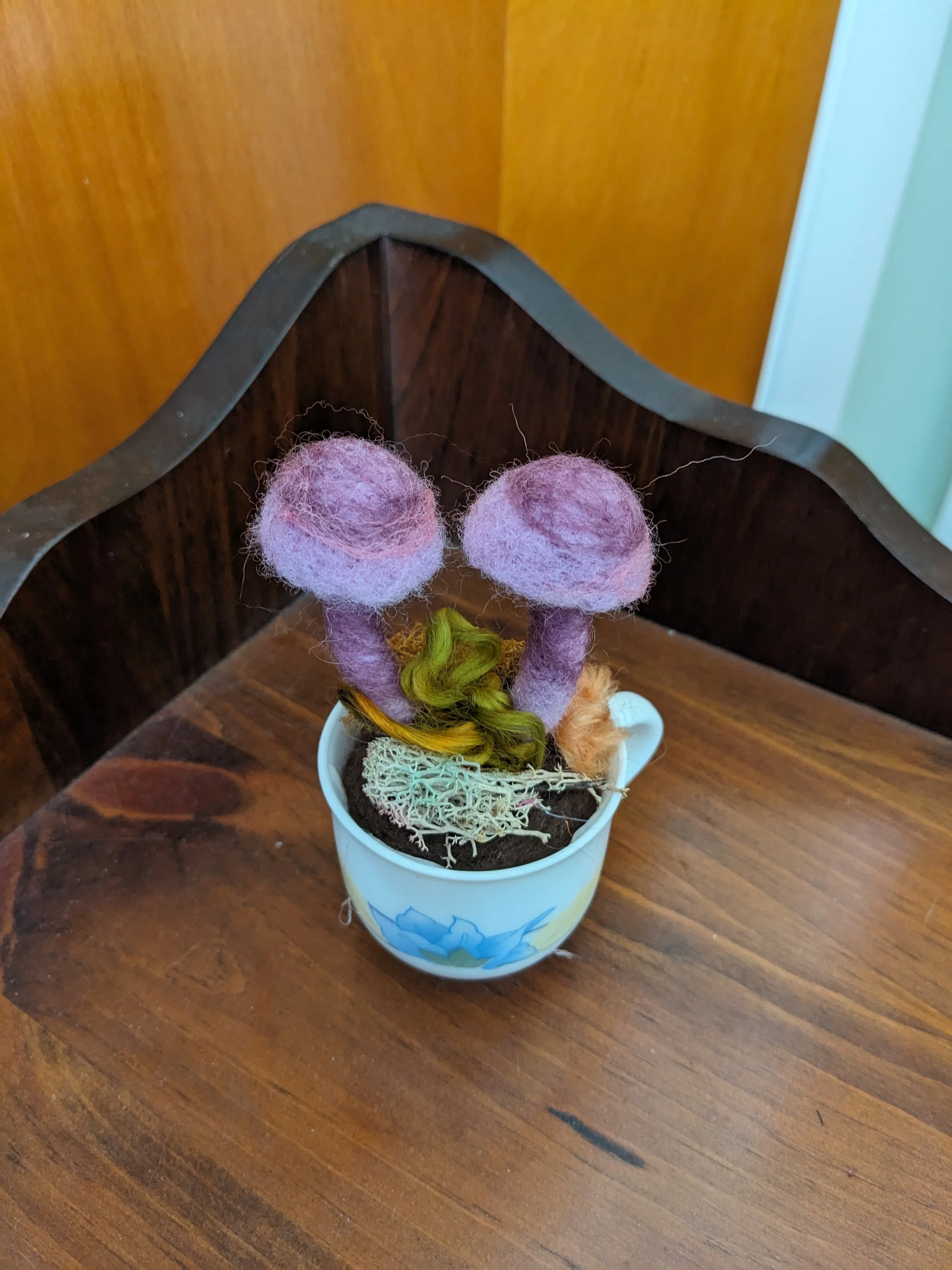 Needle felted purple mushrooms in a tea cup