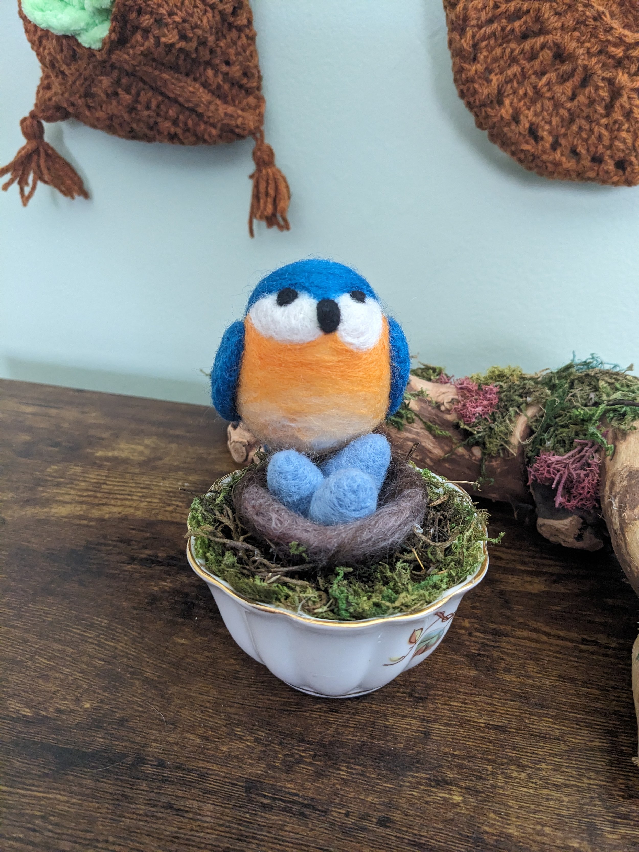 Needle felted bluebird on a nest