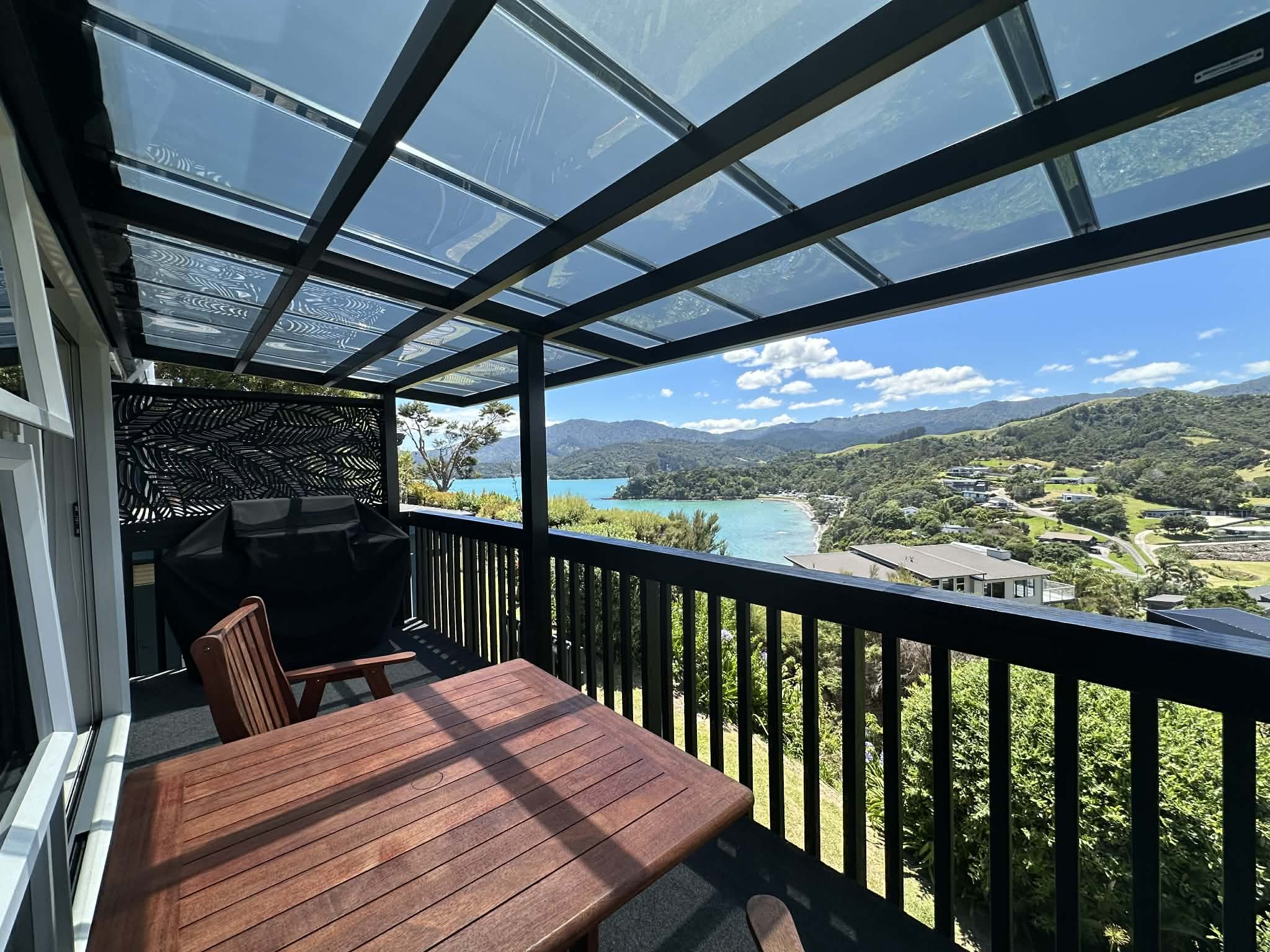 The Deluxe Studio’s private balcony offers stunning views over the turquoise bay, beach, and surrounding hills — a peaceful spot to relax and take in Coromandel’s beauty.
