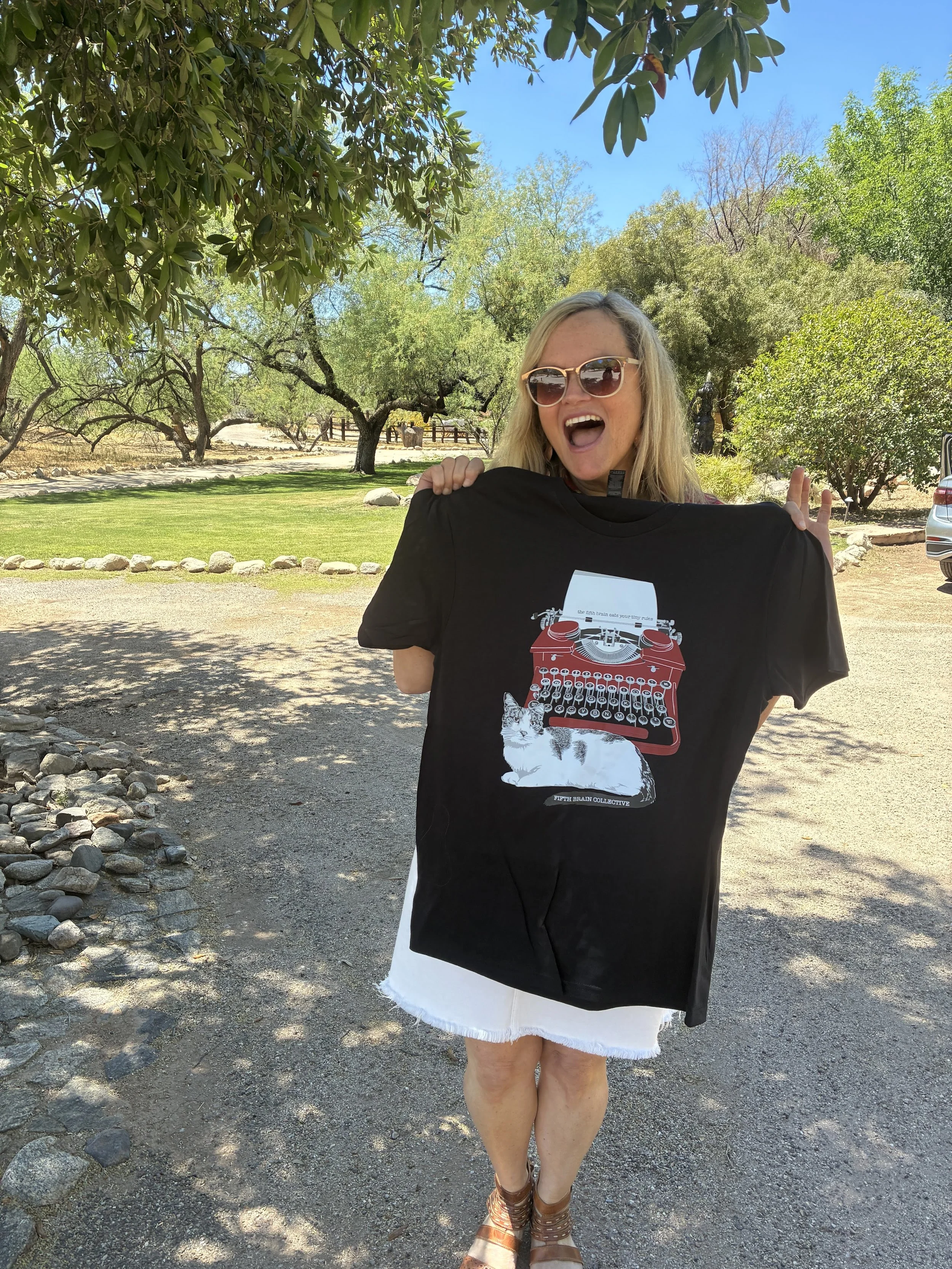 Frankie holding up the retreat t-shirt
