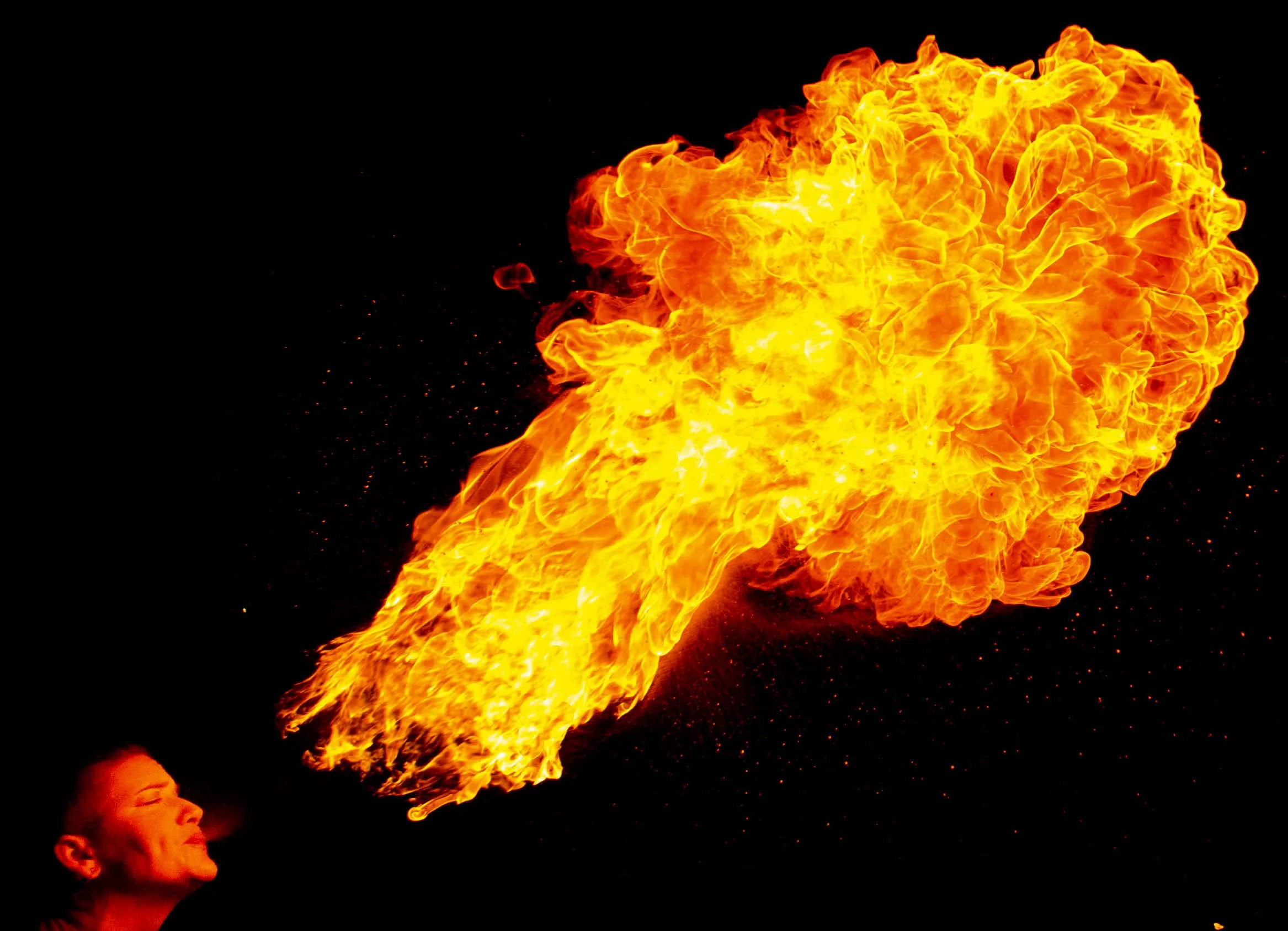 a firebreather exhales a massive fireball photograph by Life Times Photography
