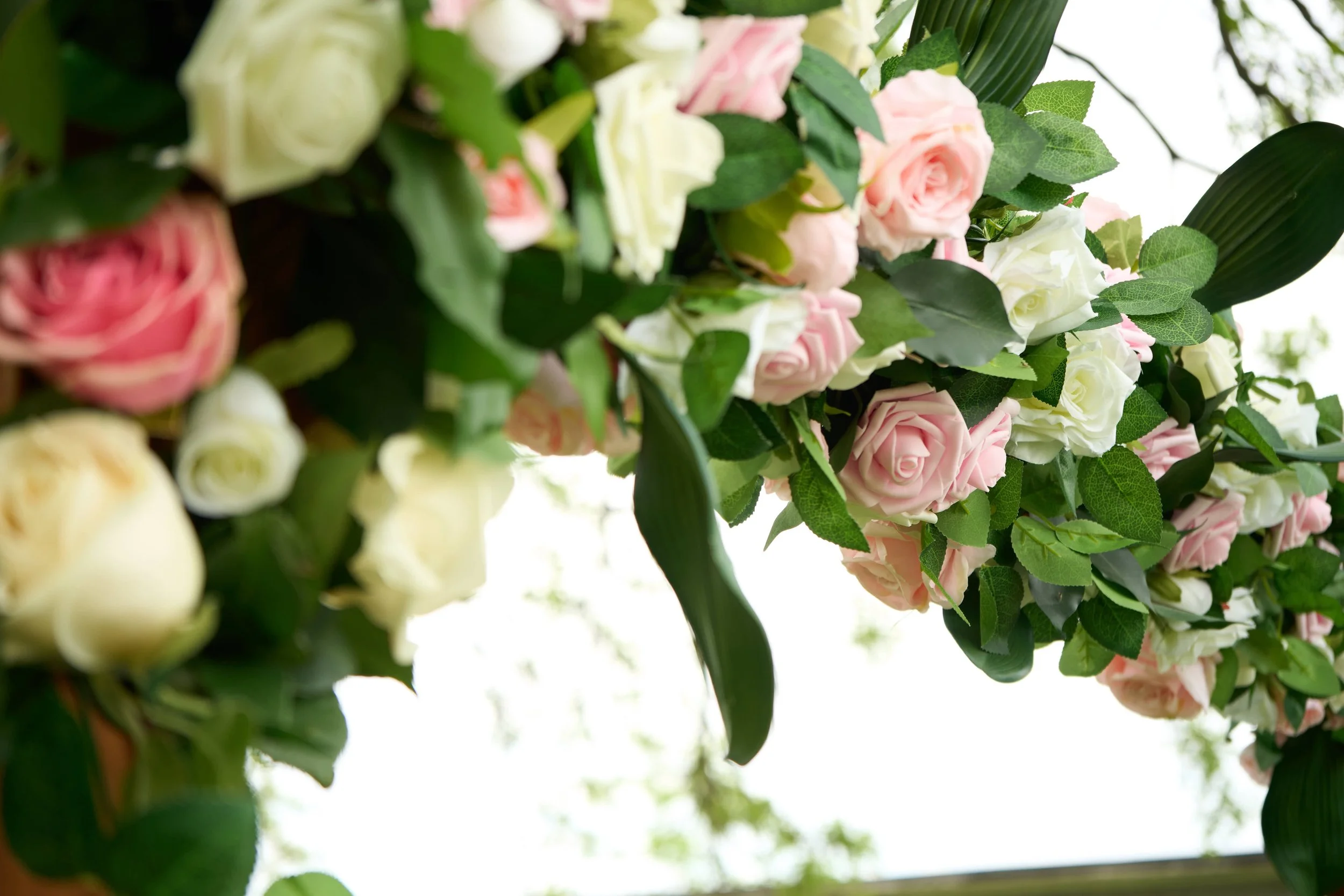 wedding arch decorated in white and pink roses