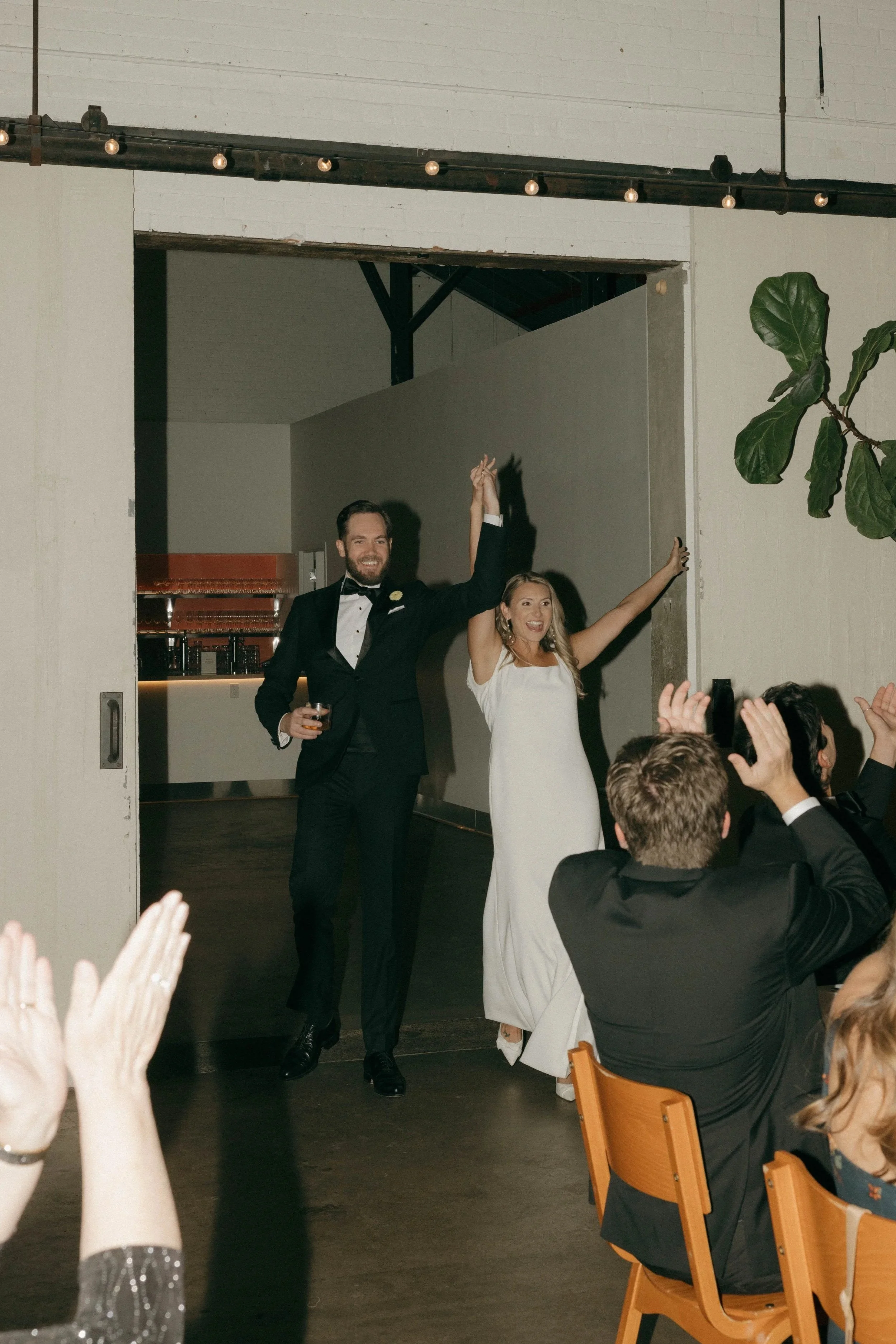 A Wedding Couple enters their reception in a celebratory mood at a wedding and event venue in St. Paul, Minnesota