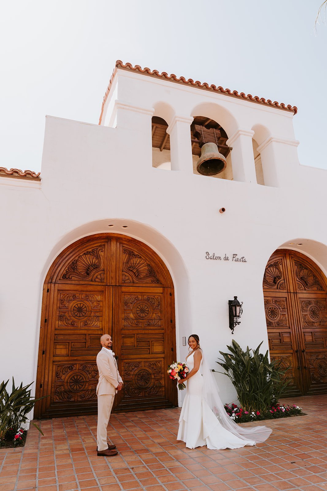 Bride and Groom in front of Spanish style door at La Quinta Resort wedding in Palm Springs | photo by Tida Svy