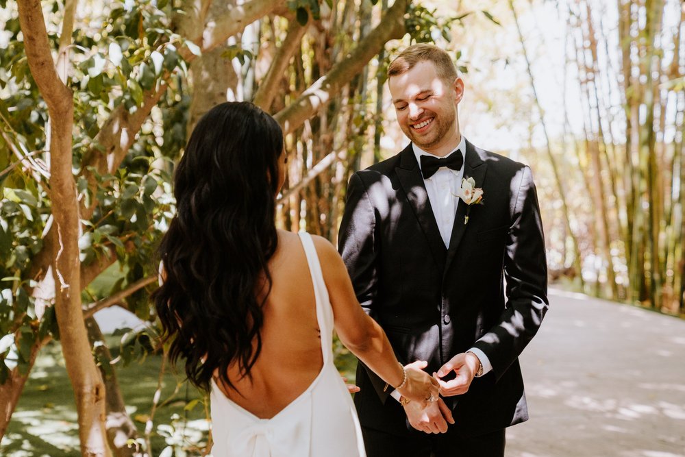 Bride and groom first look at Botanica Oceanside, photo by Tida Svy Photography