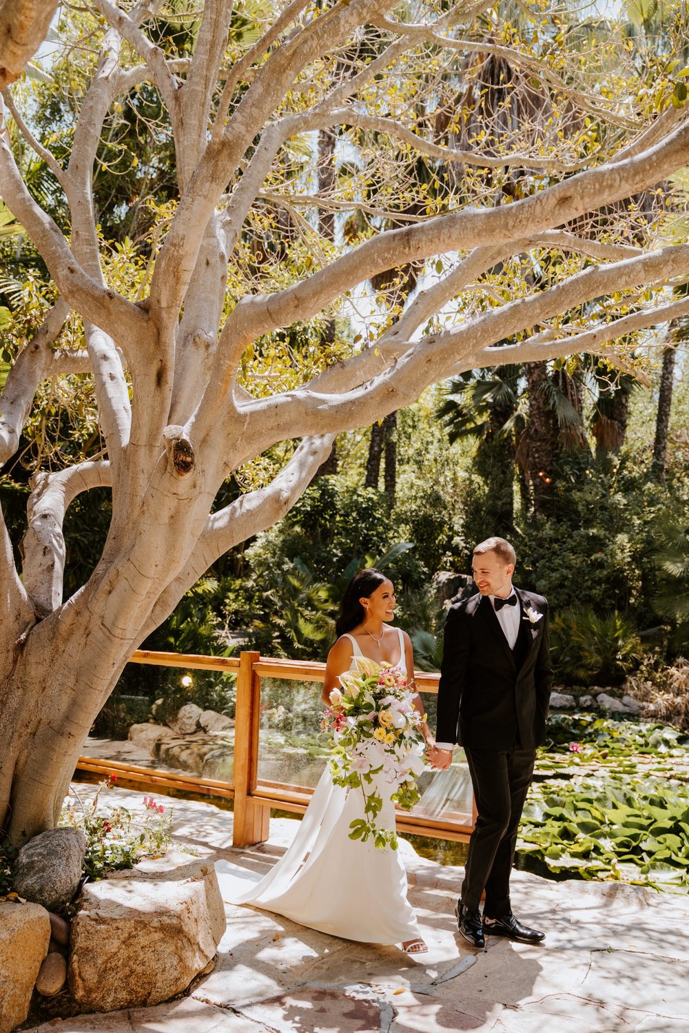 Tropical bride and groom portrait at Botanica Oceanside, photo by Tida Svy Photography, San Diego wedding photographer