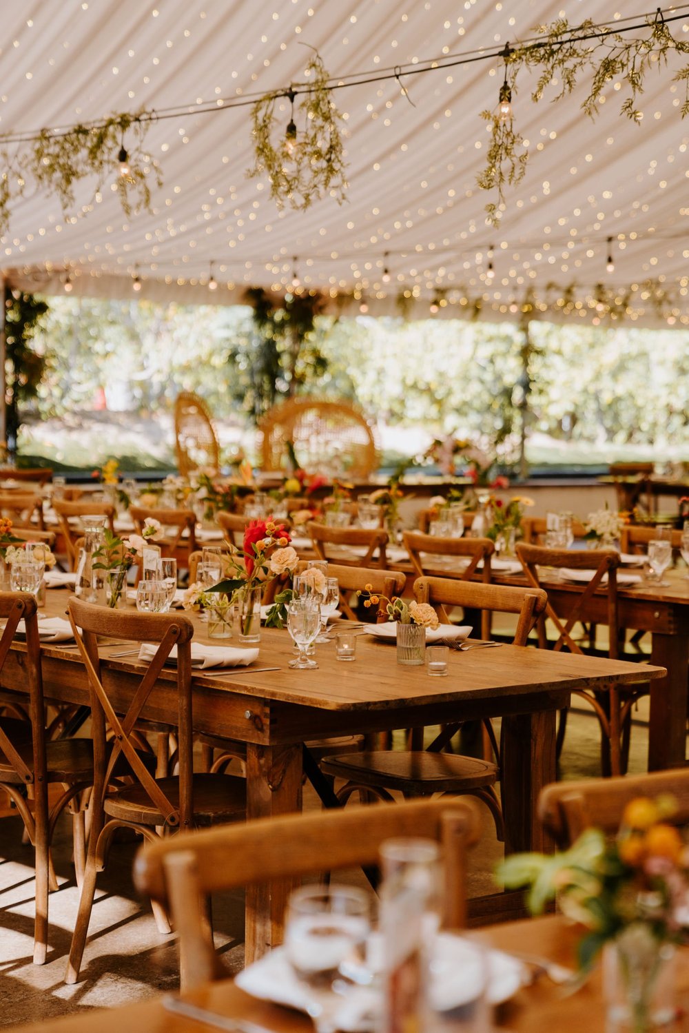 Tropical boho inspired wedding sweetheart table with peacock chairs. Botanica Oceanside wedding reception, San Diego wedding venue, photo by TIda Svy, San Diego wedding photographer