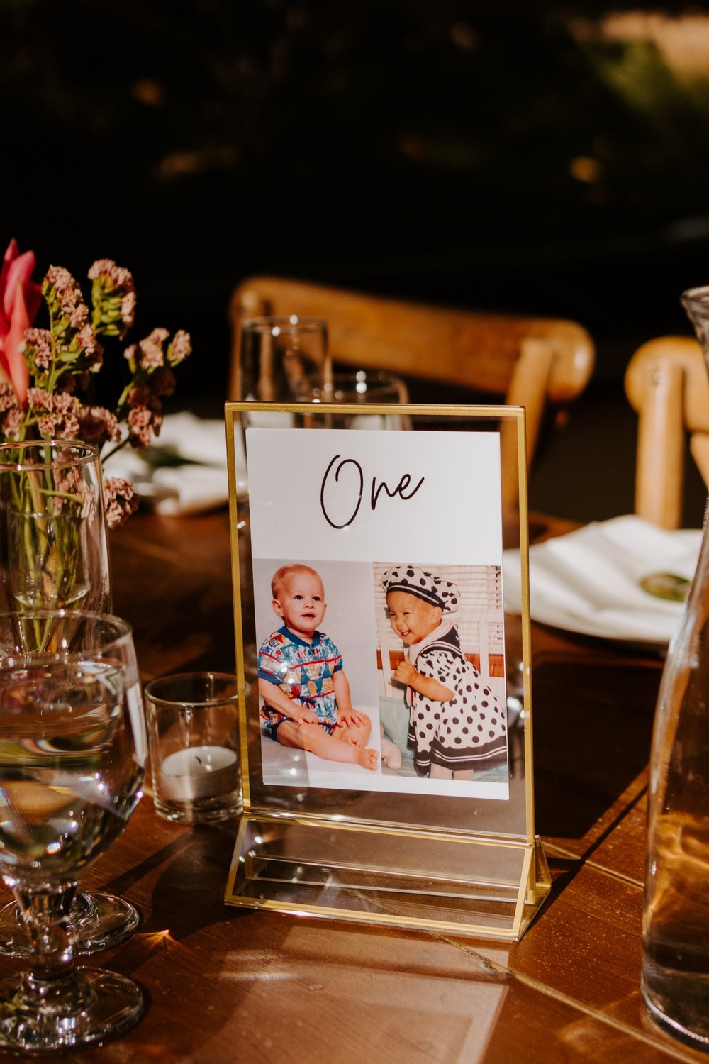 Tropical boho inspired wedding reception, Table numbers with bride and groom photos, Botanica Oceanside wedding reception, San Diego wedding venue, photo by TIda Svy, San Diego wedding photographer