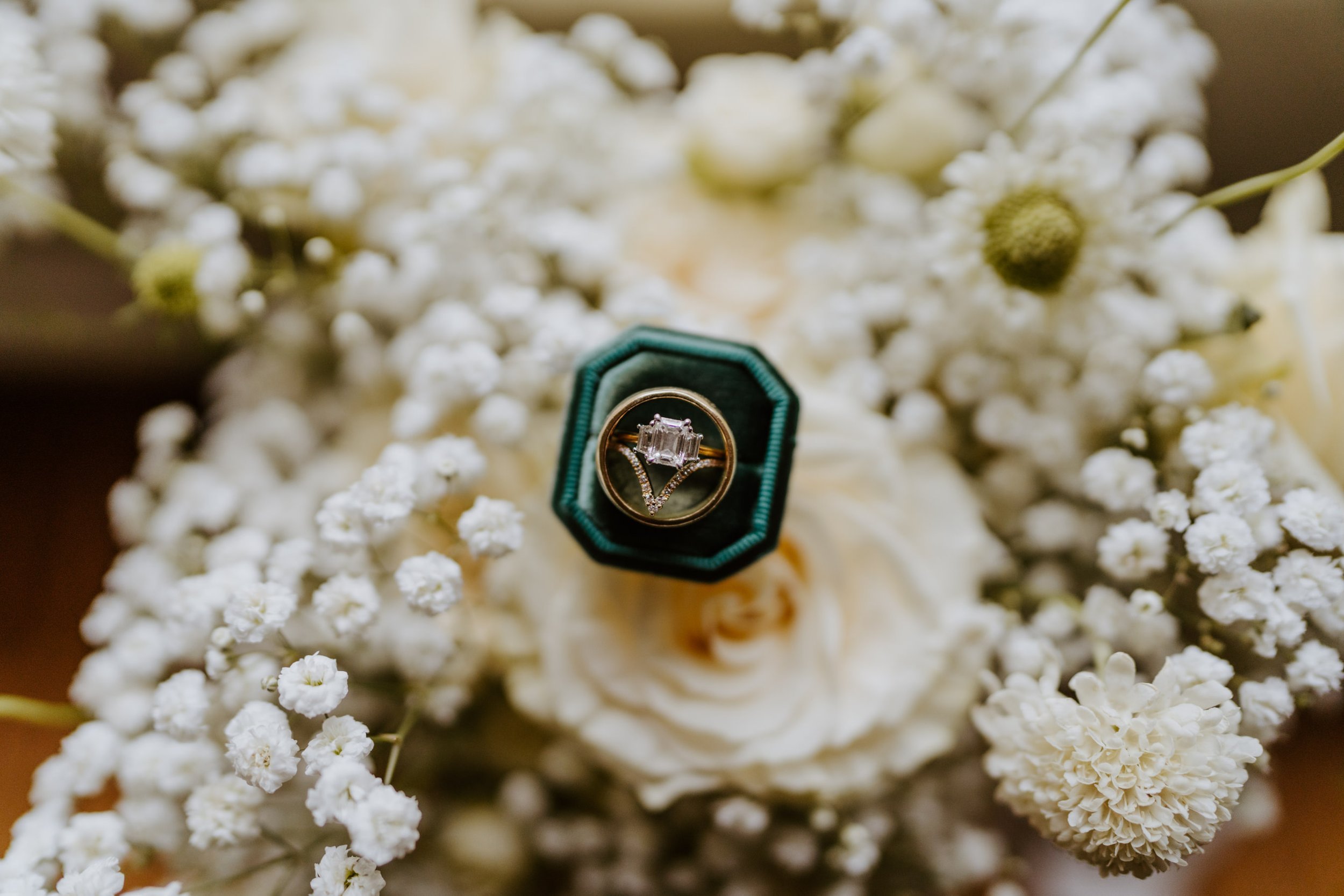 Bride getting ready detail photo Green velvet ring box, white baby’s breath bouquet, photo by Tida Svy, Los Angeles Wedding Photographer