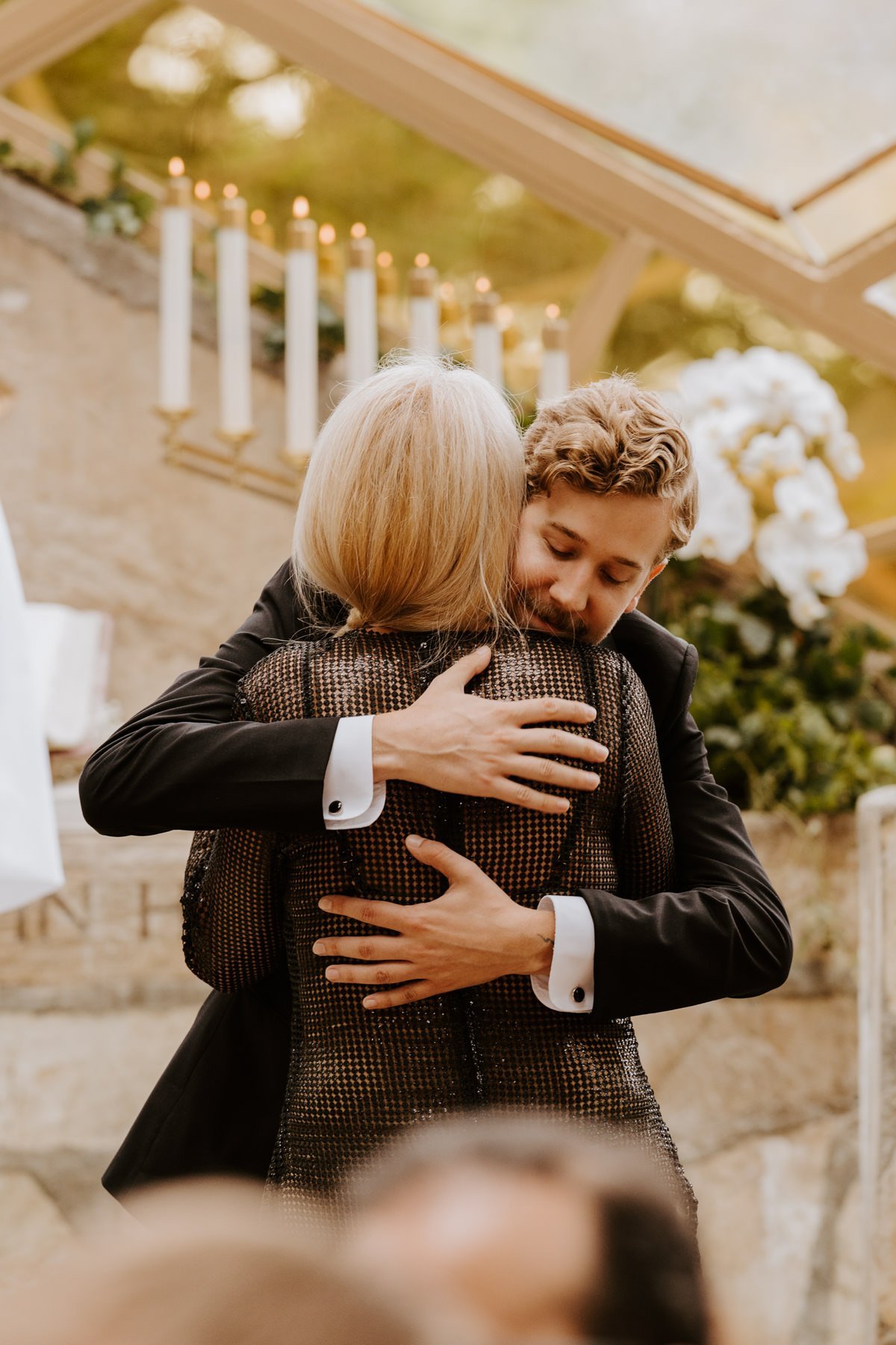 Groom and mom hugging at altar, Wayfarers Chapel Wedding, Photo by Tida Svy, Los Angeles Wedding Photographer