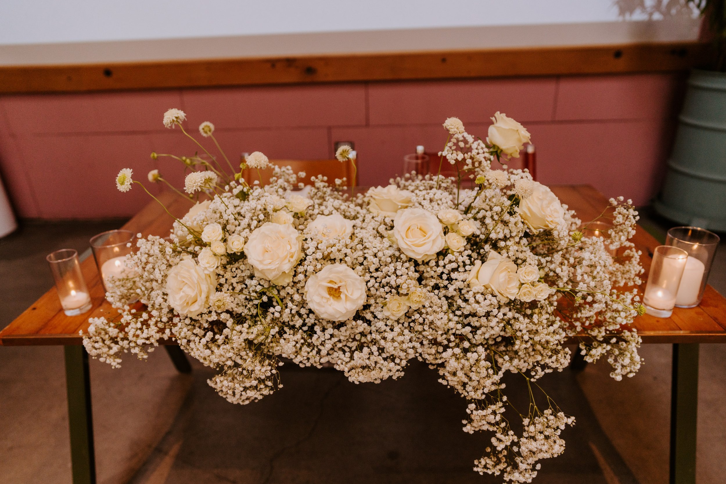 Whimsical white rose and baby’s breath wedding sweetheart table, grass room dtla, photo by Tida Svy, Los Angeles Wedding Photographer