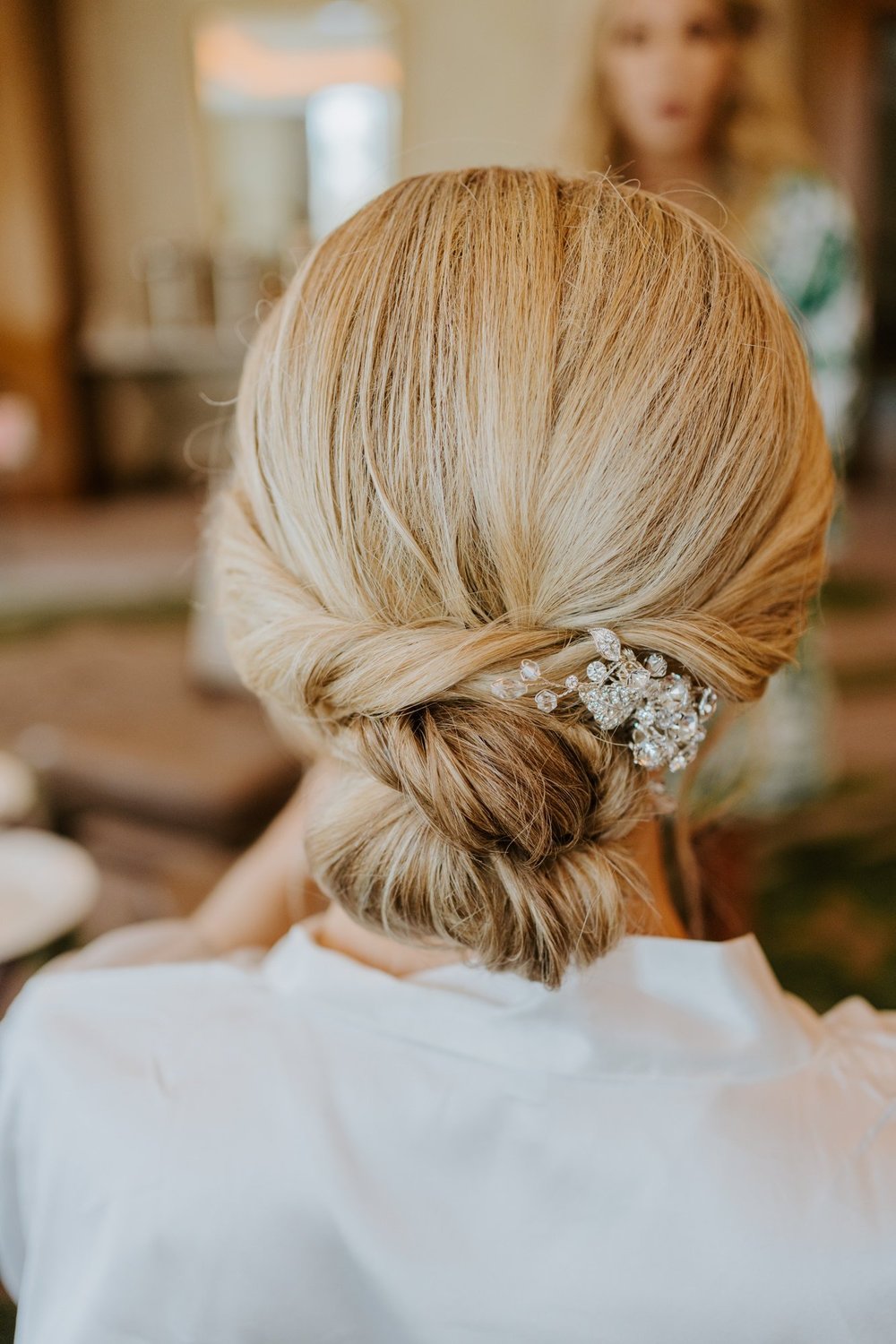 Elegant and classic low bun wedding hairstyle by Jen Plus Colour in Palm Springs, photography by Tida Svy