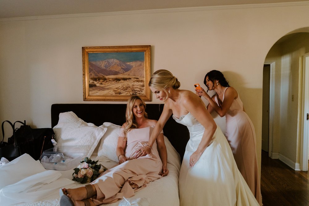 Bride and pregnant bridesmaid getting ready at The O’Donnell House wedding in Palm Springs, photography by Tida Svy