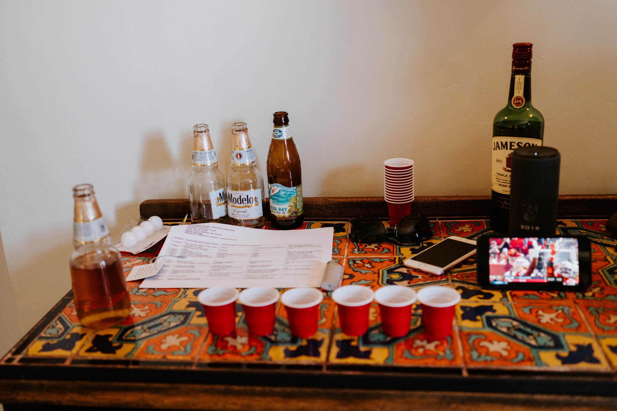 Shot glasses lined up for groomsmen getting ready at The O’Donnell House wedding in Palm Springs, photography by Tida Svy