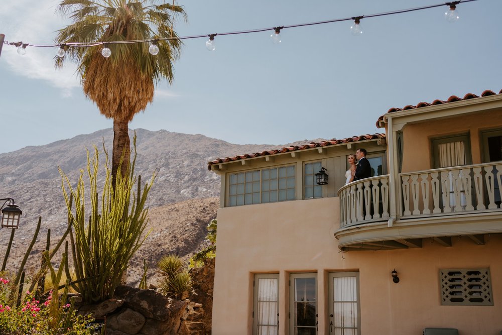 Bride and Groom on top balcony at The O’Donnell House Palm Springs, photography by Tida Svy