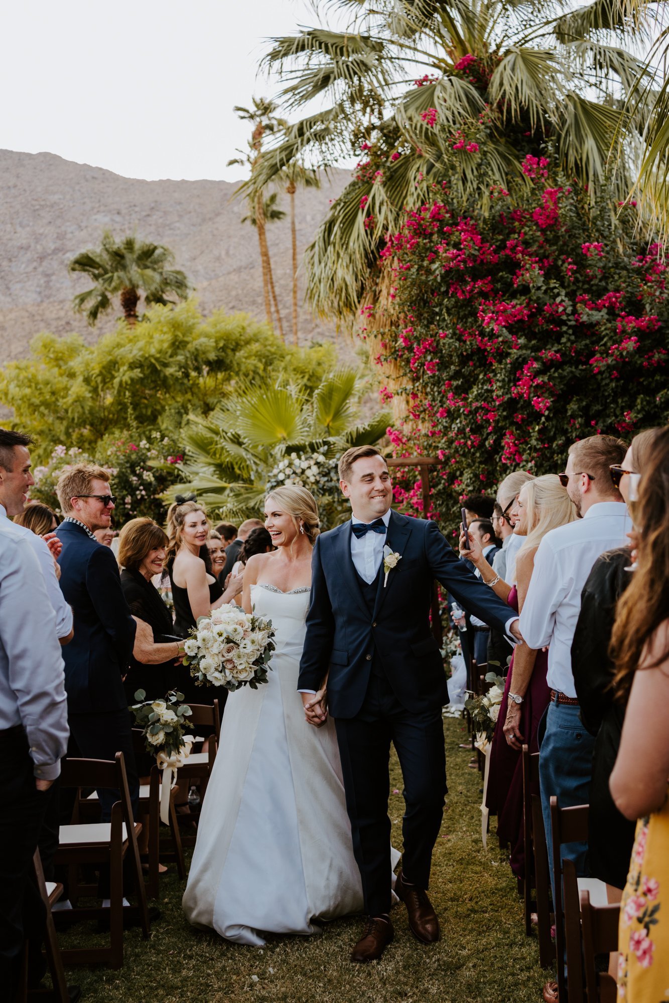 Sunset Wedding ceremony bride and groom walking down the aisle at The O’Donnell House wedding in Palm Springs, vibrant southern california wedding photography by Tida Svy