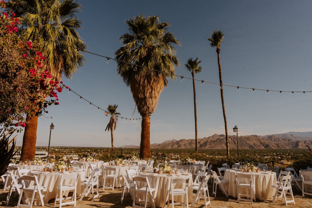 Summer wedding reception set up with simple white chair and tables at The O’Donnell House Palm Springs, vibrant wedding photography by Tida Svy