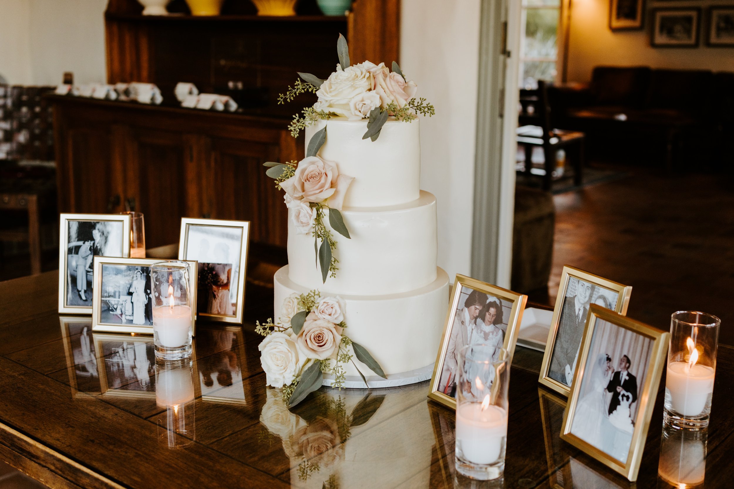 Elegant and simple white wedding cake with flowers and ancestry table at wedding, The O’Donnell House Palm Springs, Tida Svy Photography