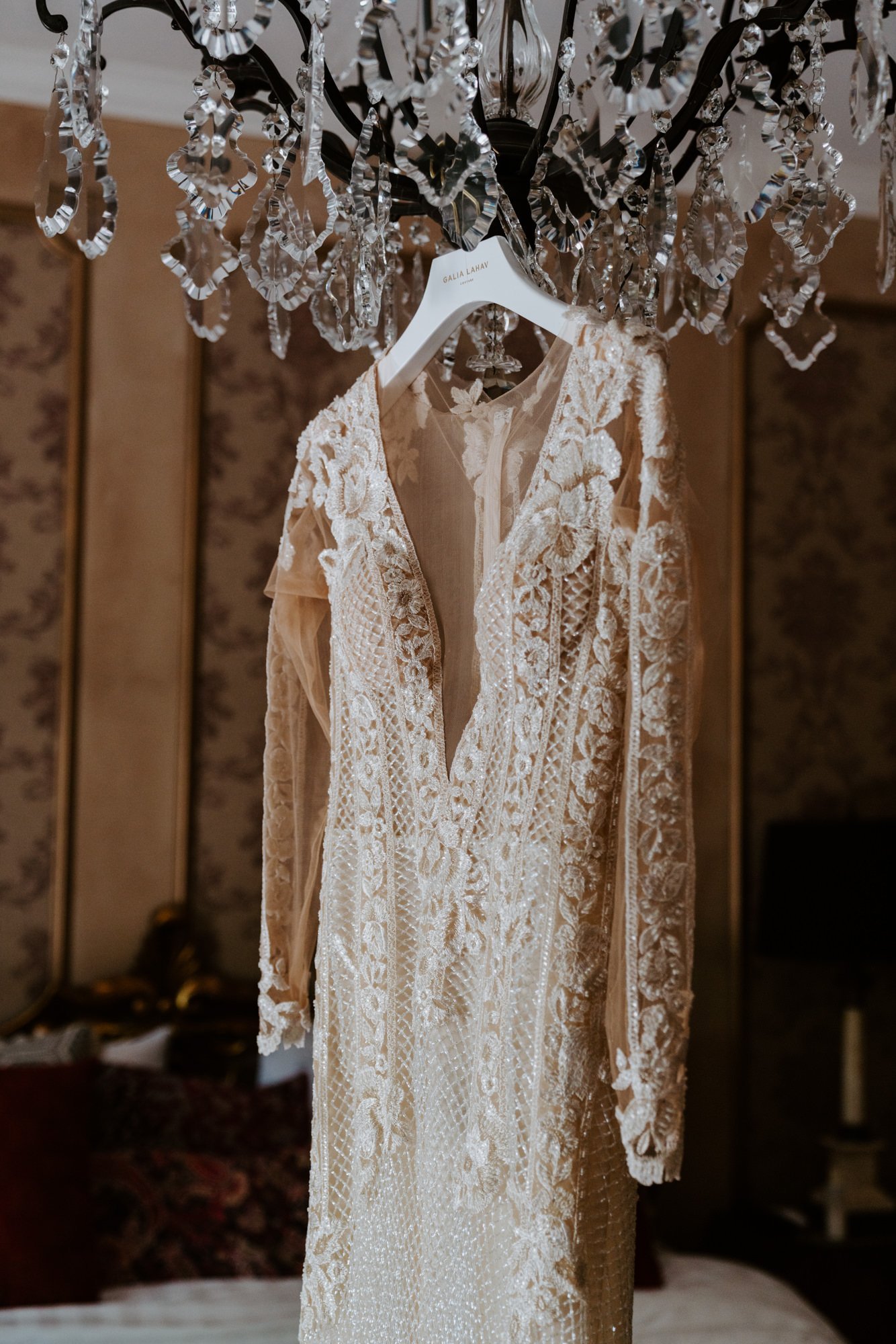 Galia Lahav bridal dress hanging from chandelier at  The Houdini Estate Wedding, Los Angeles Wedding Photography by Tida Svy